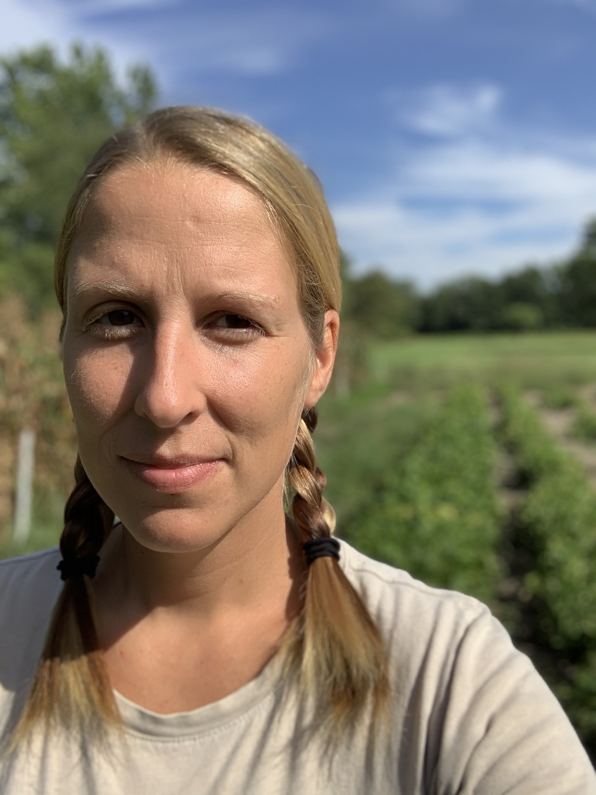 artist Josie Cooke standing outside in the sun