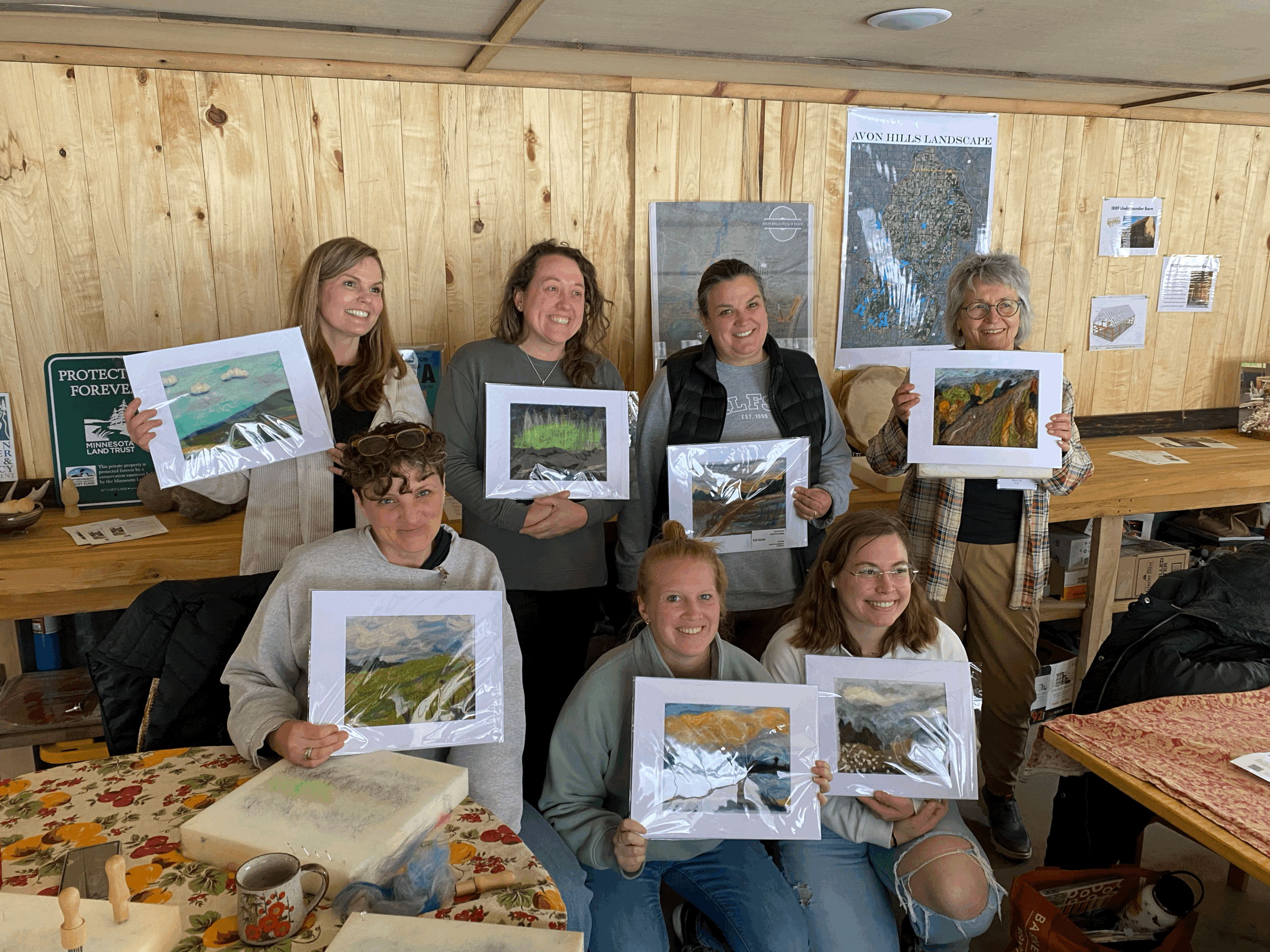 group of woman standing together with their needle felting projects
