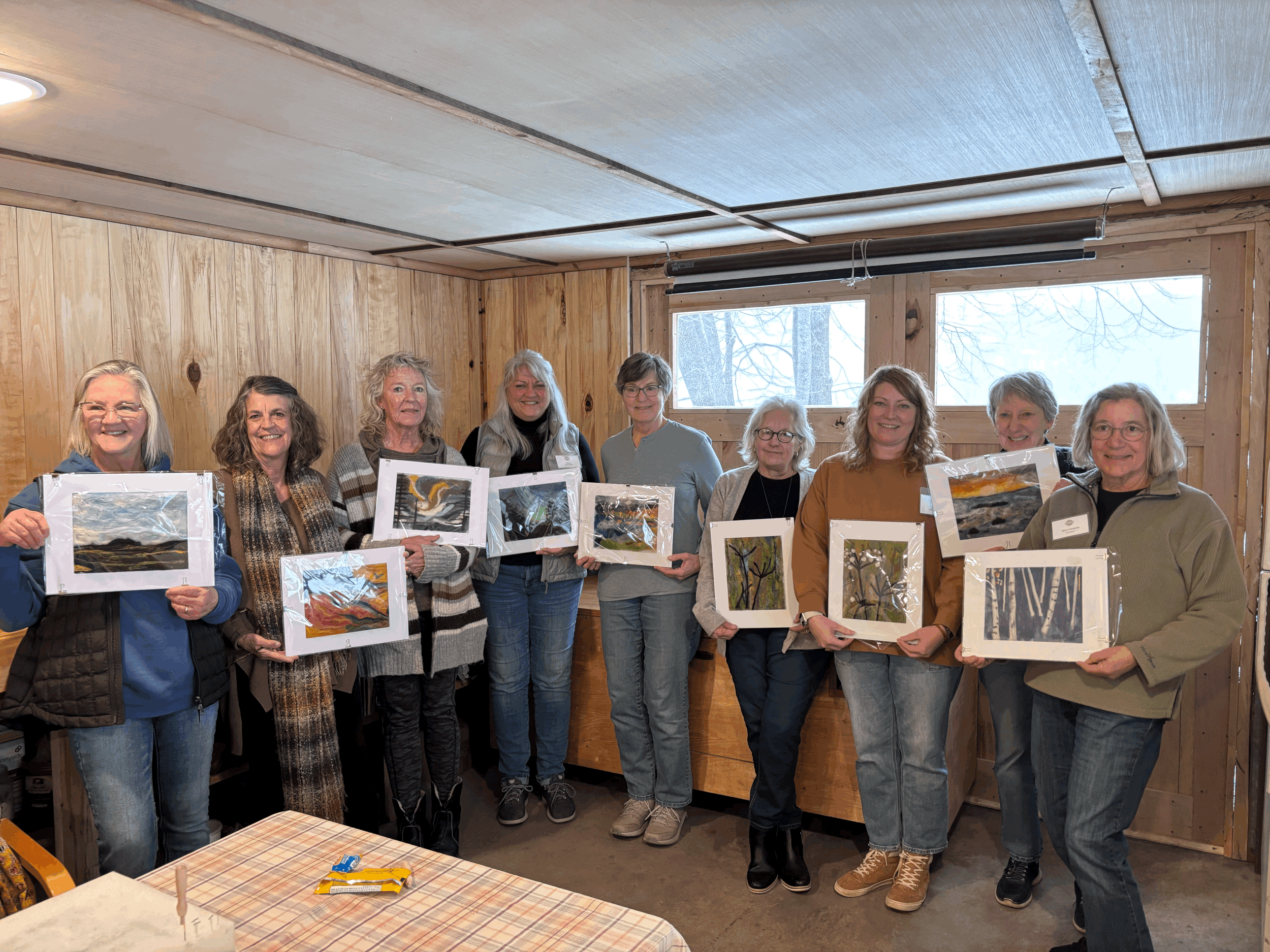group of woman standing together with their needle felting projects