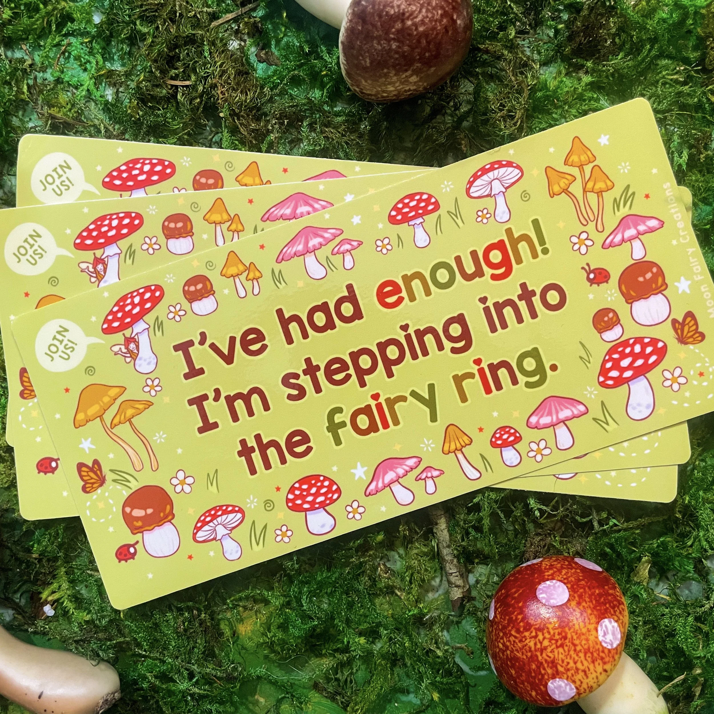 a pile of bumper stickers. They say "I've had enough! I'm stepping into the fairy ring!" with mushrooms illustrated around the edges.