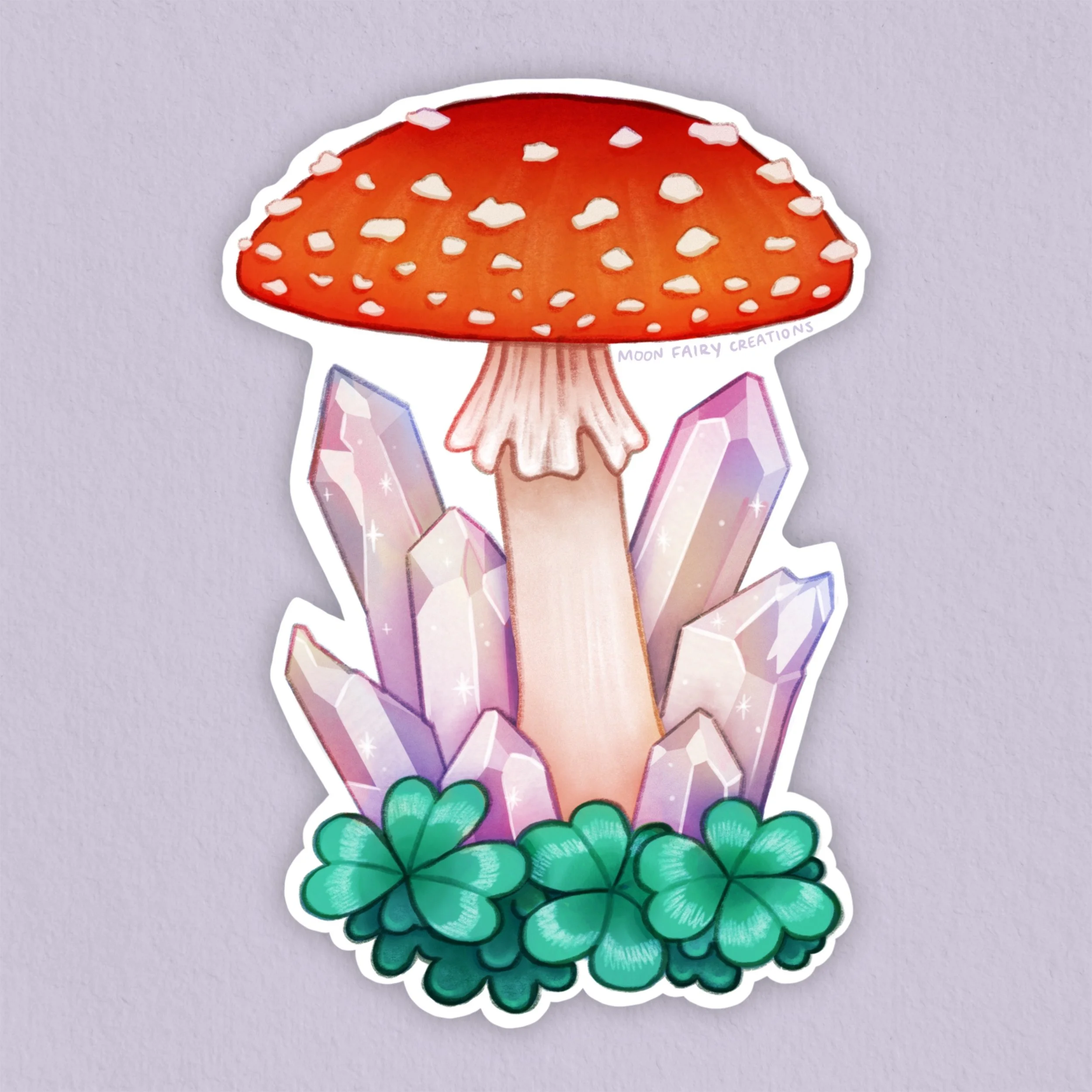 a sticker depicting a red amanita mushroom with crystals and clovers