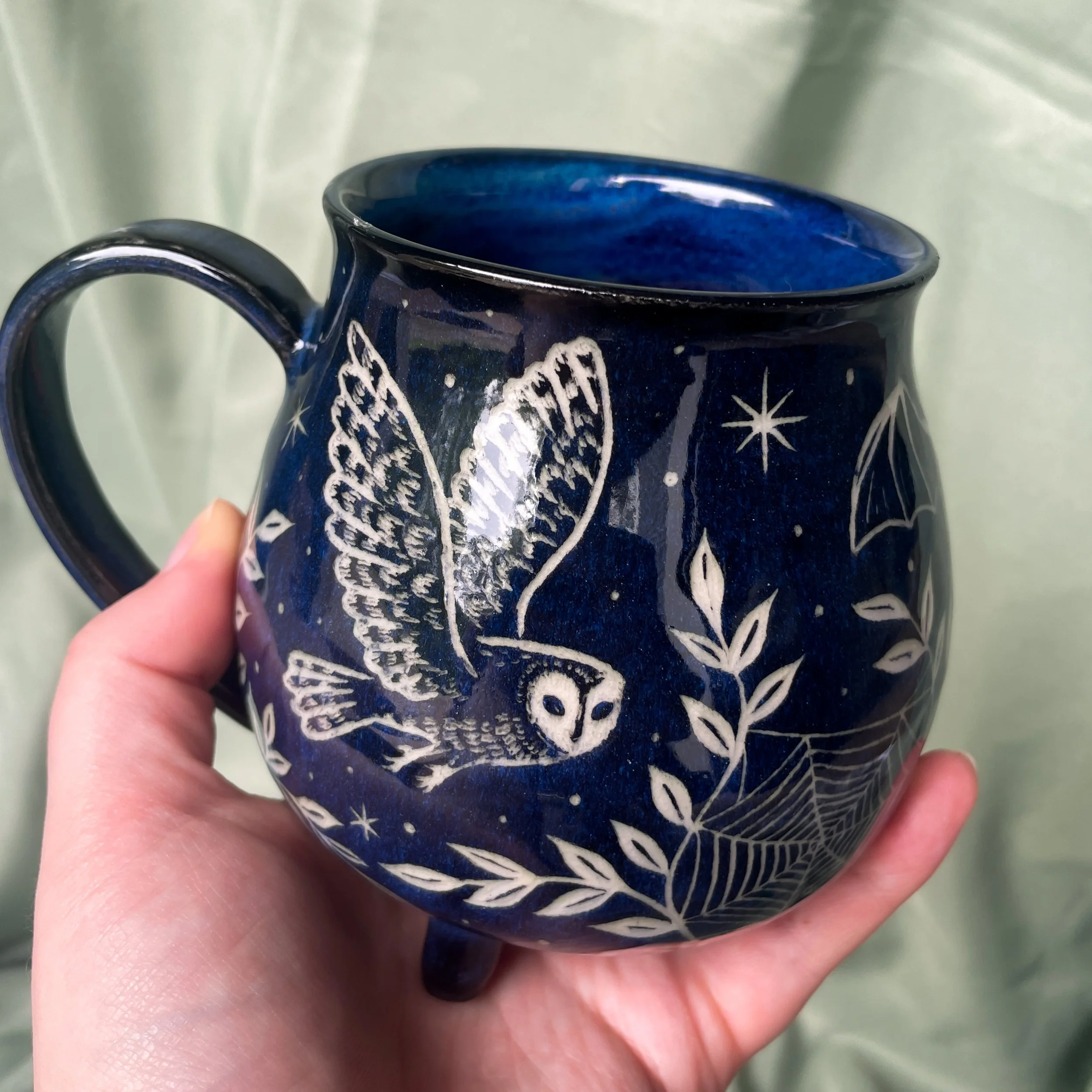 nocturnal creatures cauldron mug held up.JPEG