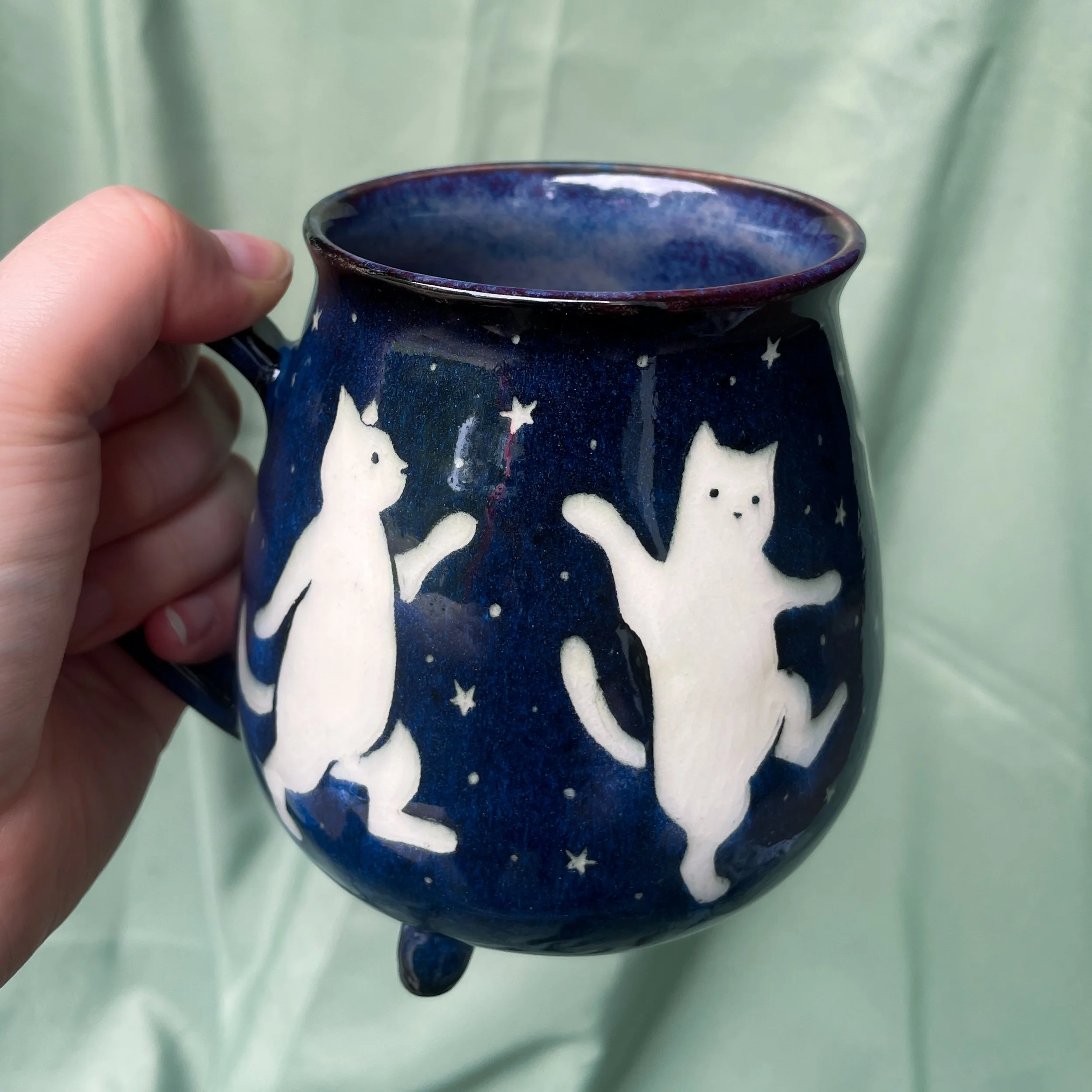 cat cauldron mug held up.JPEG