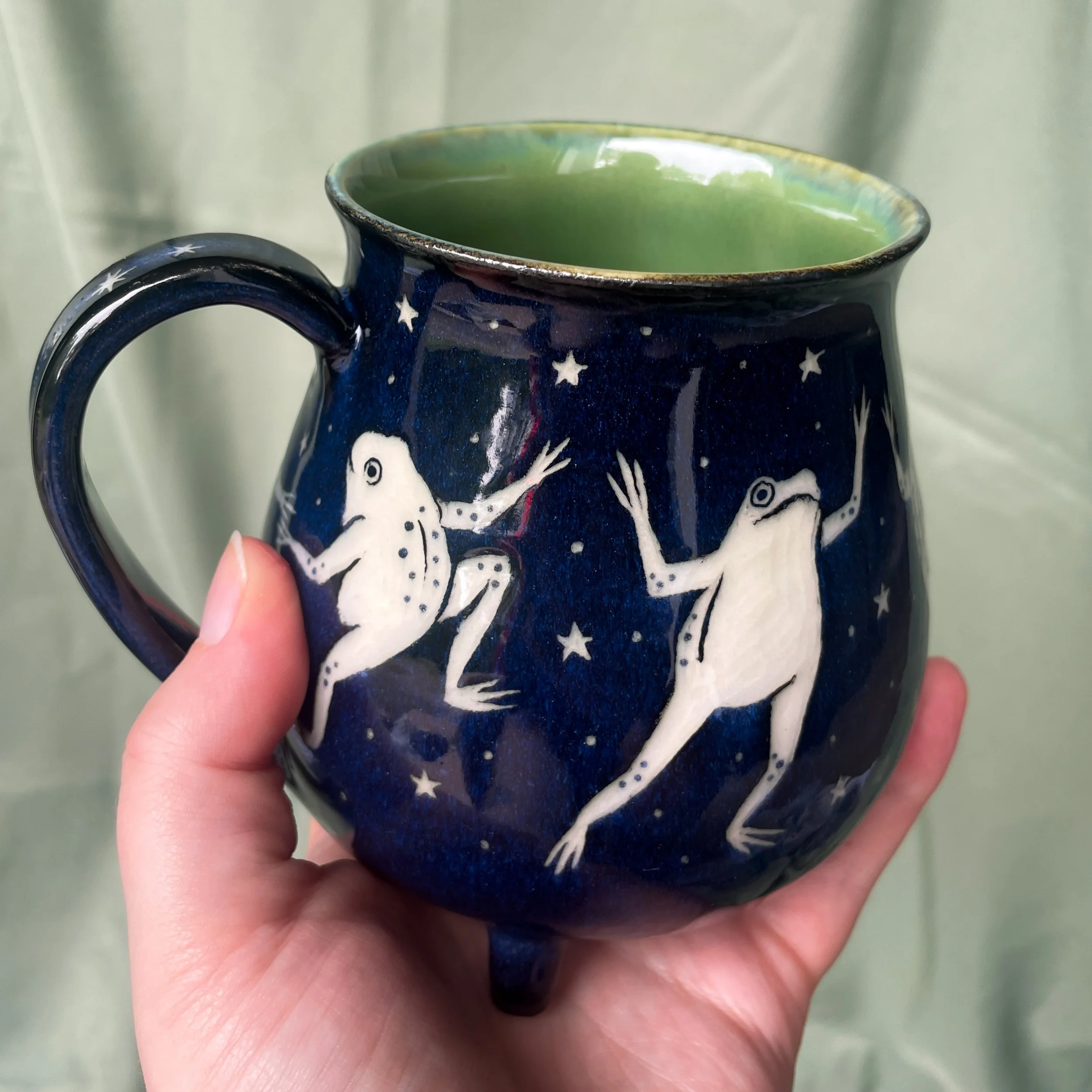dancing frog cauldron mug b held up 2.JPEG