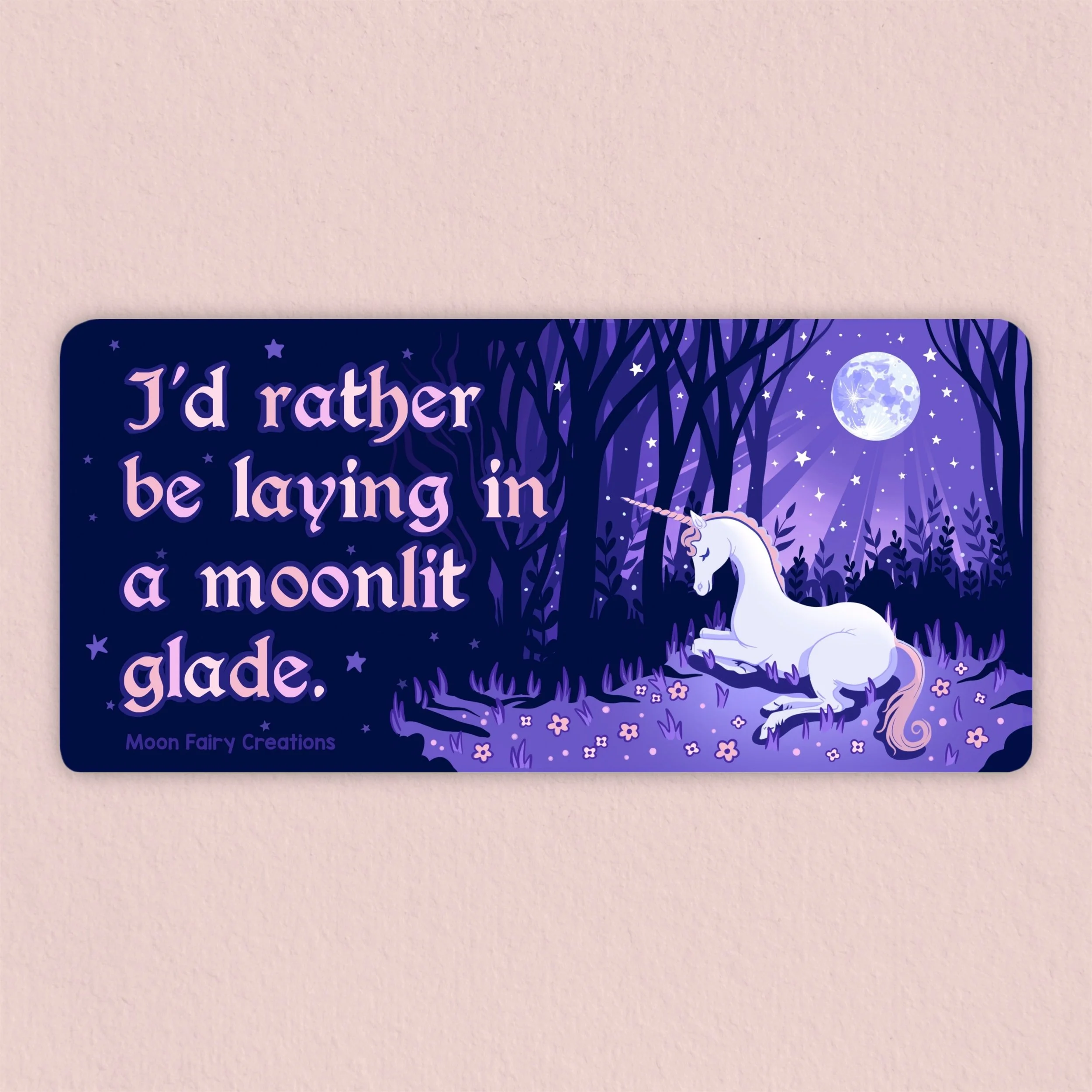 Bumper sticker that says "I'd rather be laying in a moonlit glade" with a unicorn laying in a purple moonlit forest