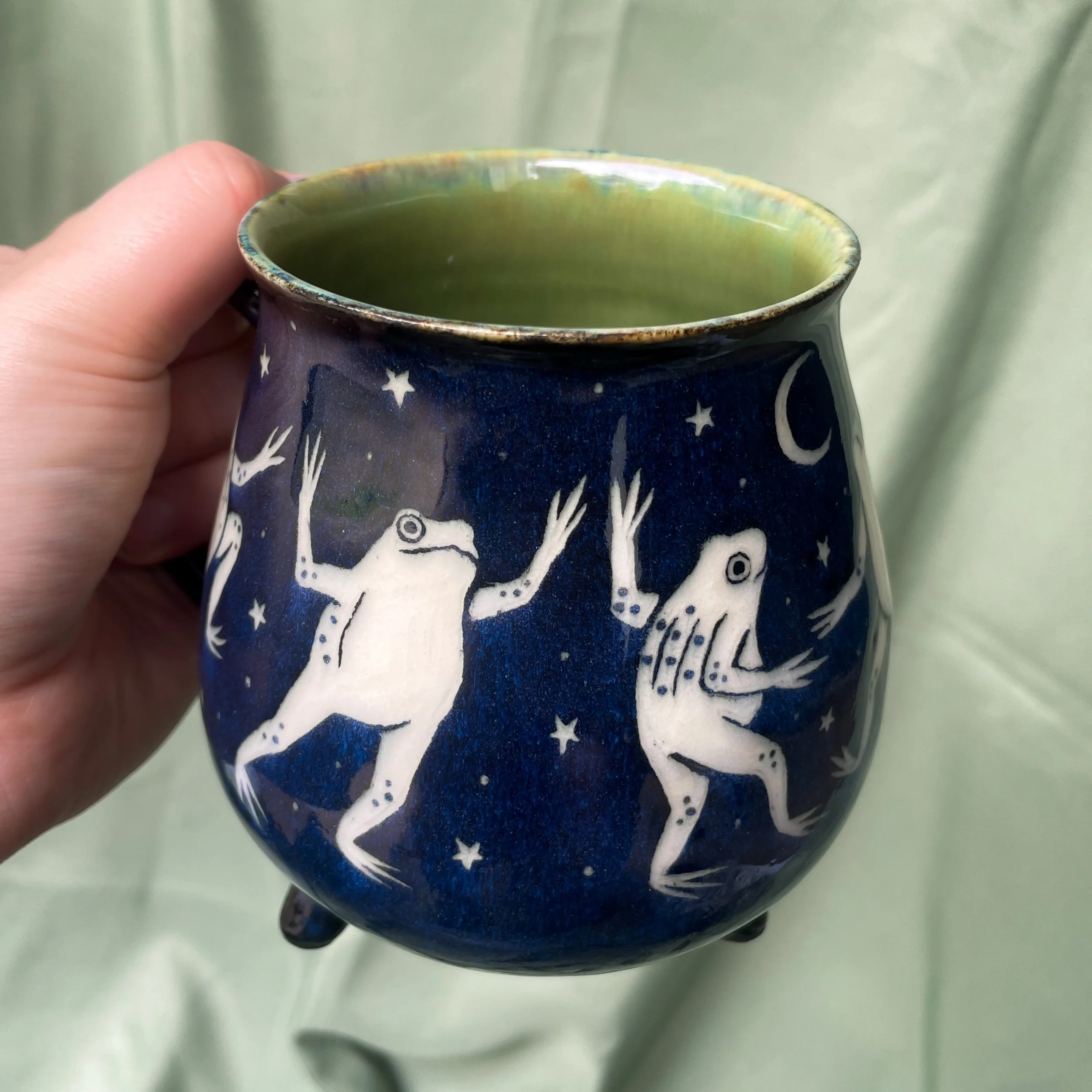 dancing frog cauldron mug a held up 2.JPEG