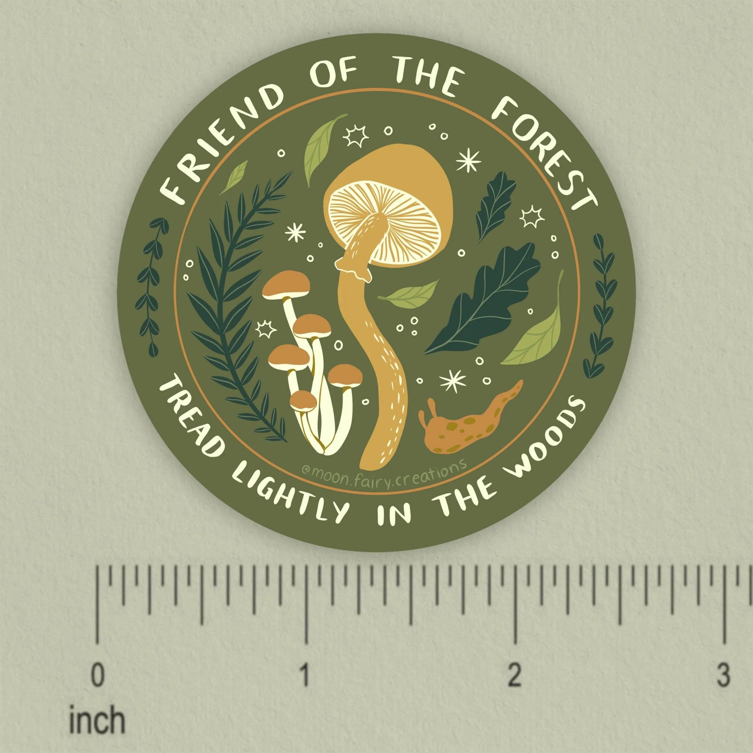 a sticker of forest elements and the words friend of the forest, tread lightly in the woods, with a ruler for scale