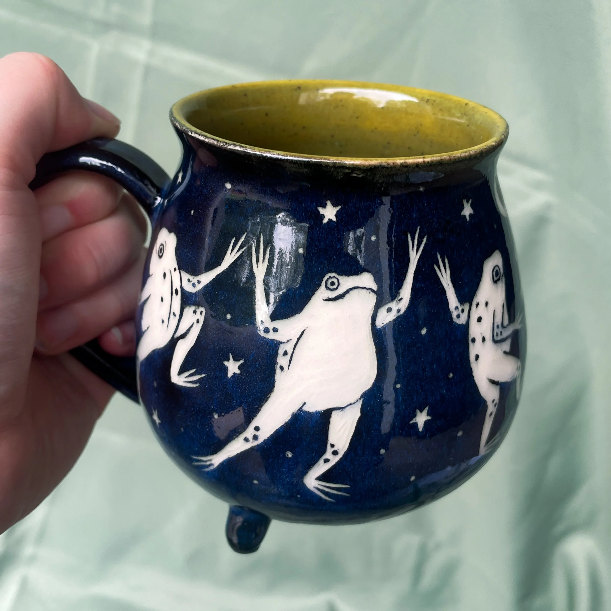dancing frog cauldron mug c held up.JPEG