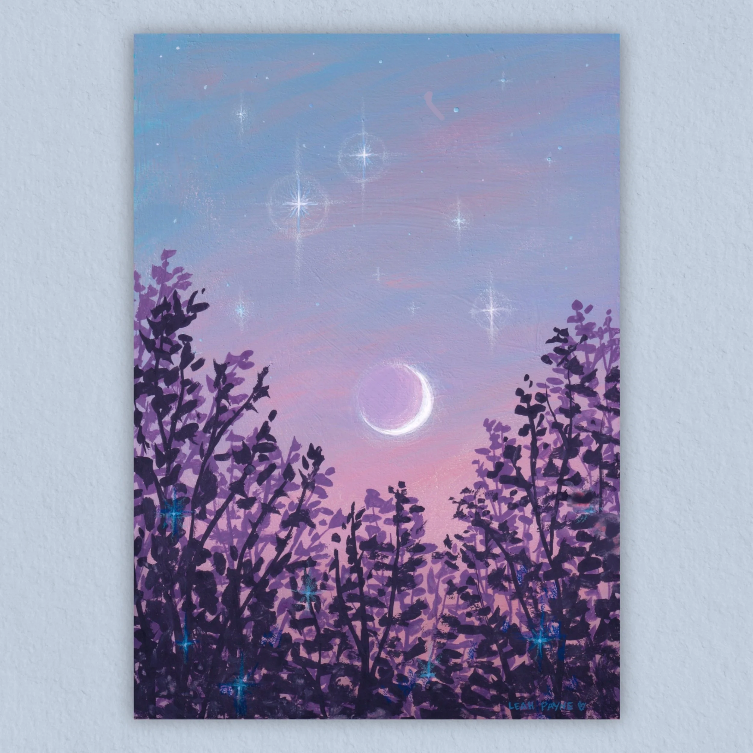 photo of an art print depicting a crescent moon in an evening sky on a pale blue background.