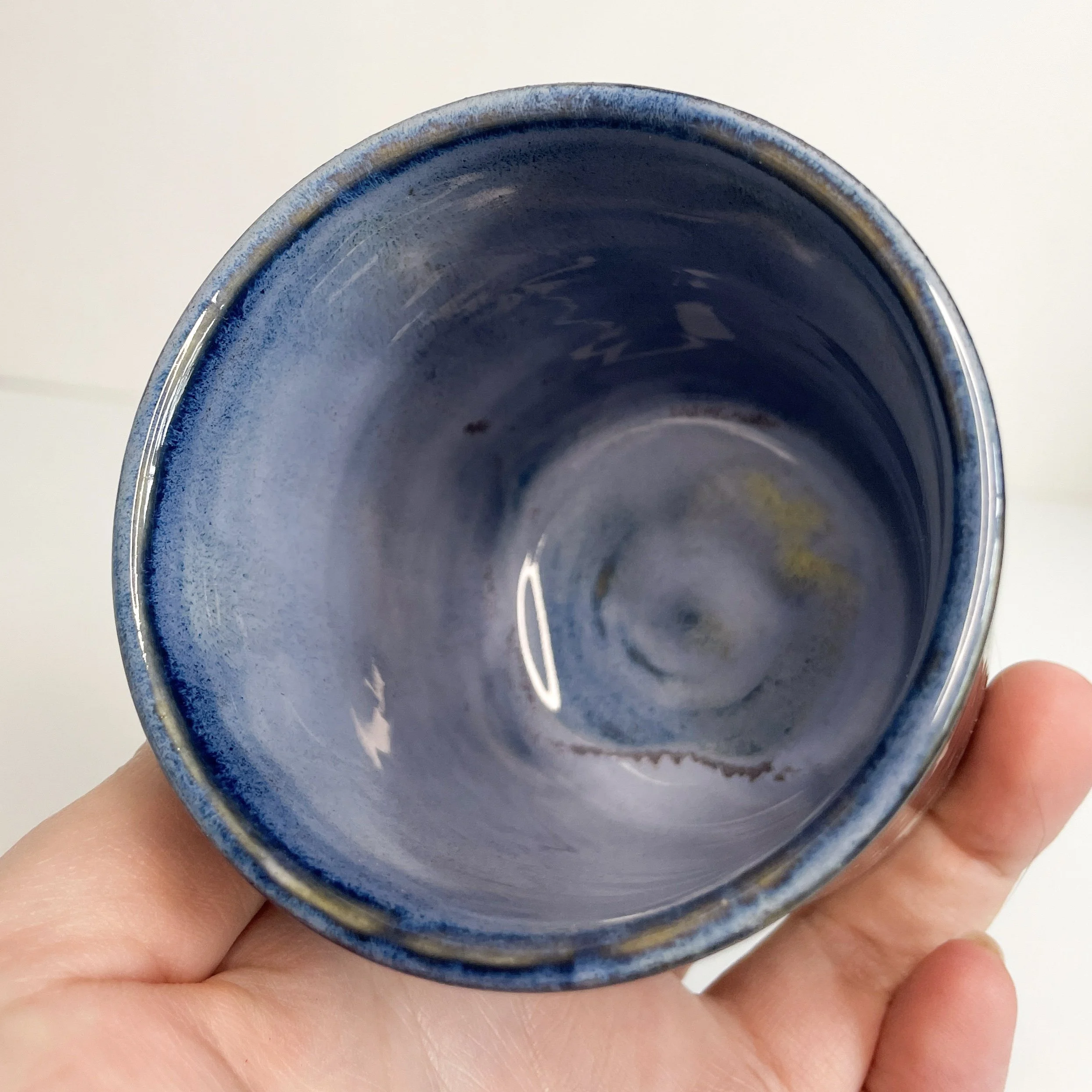 photo of the interior of the cup. it is a light to medium cloudy blue.