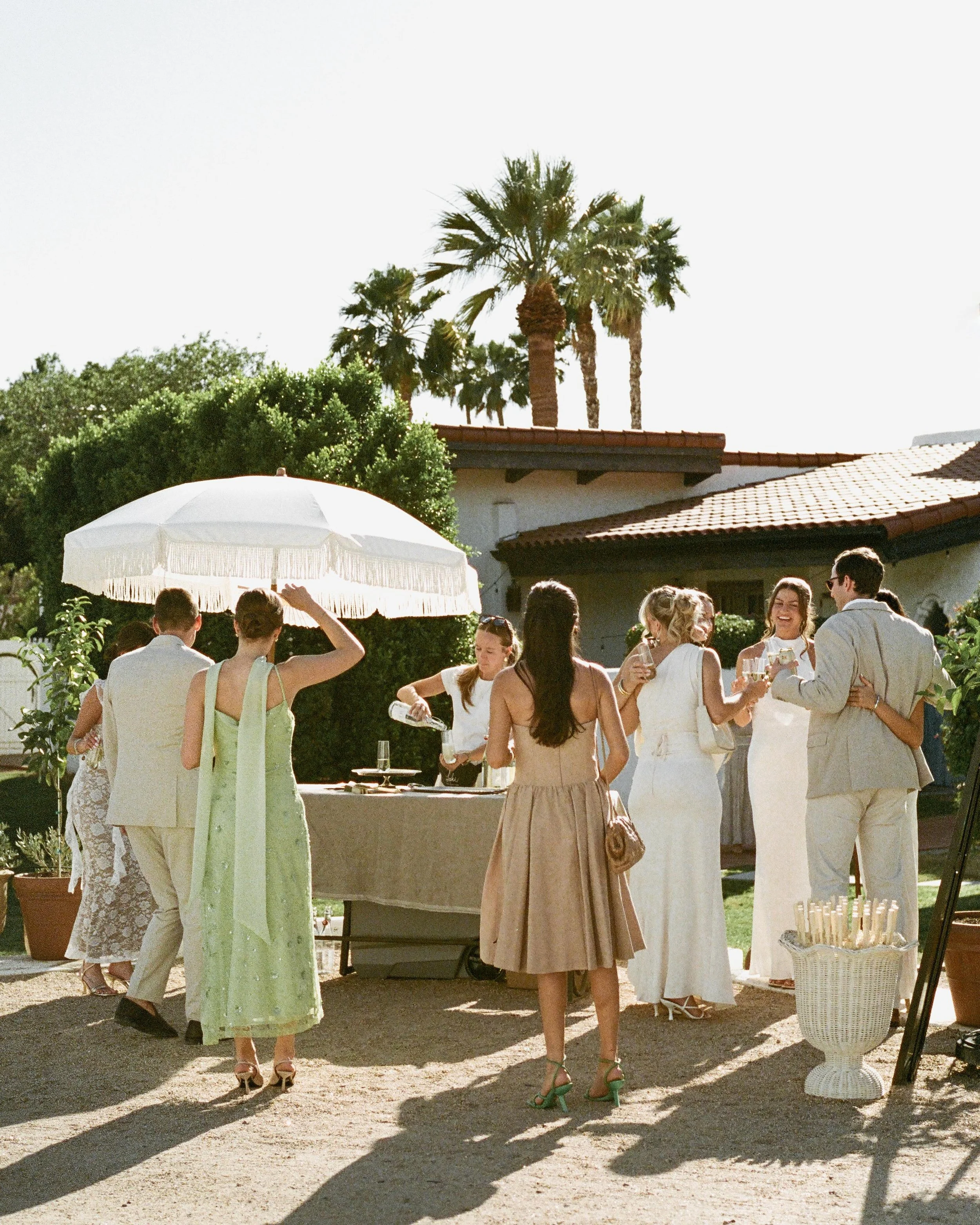 Christine and Jake were inspired to start their wedding day with genuine connection. Before the ceremony, they greeted their guests with champagne and big hugs as they arrived at the venue. 

While the dress code called for whites and creams, Christi