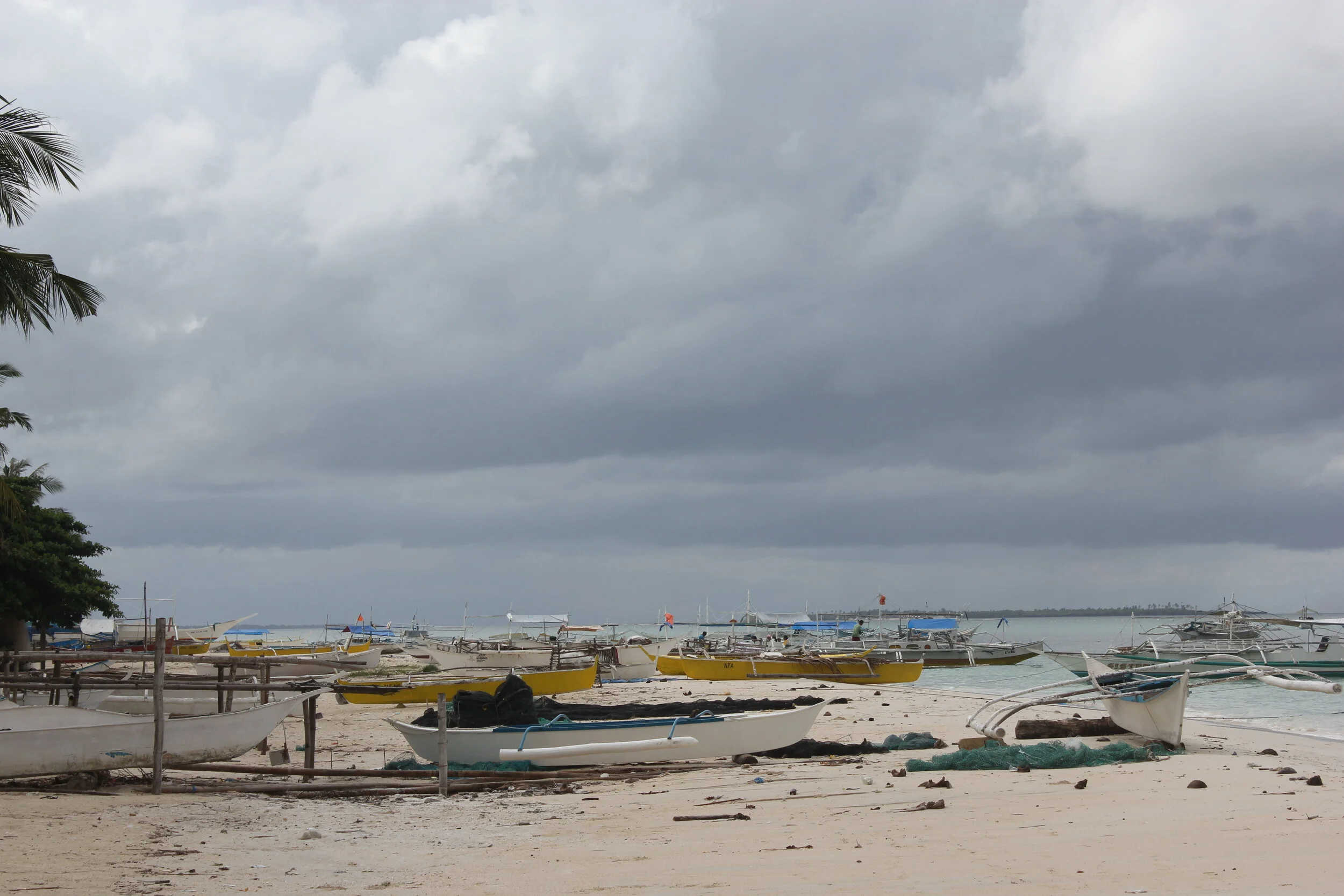Small fishing boats line the coast