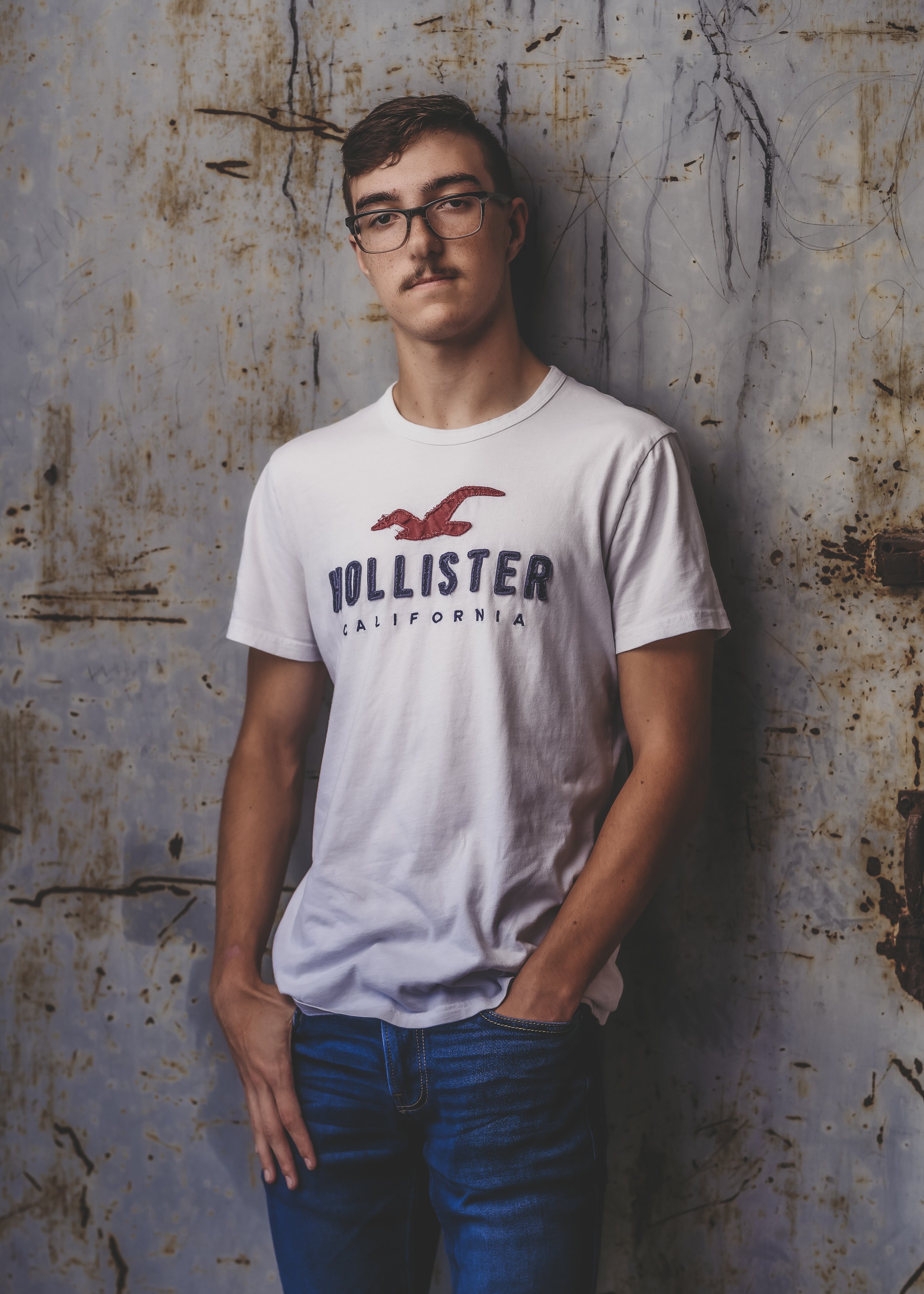 Guy in urban environment in Lenoir City. This is a senior session for this Midway football player