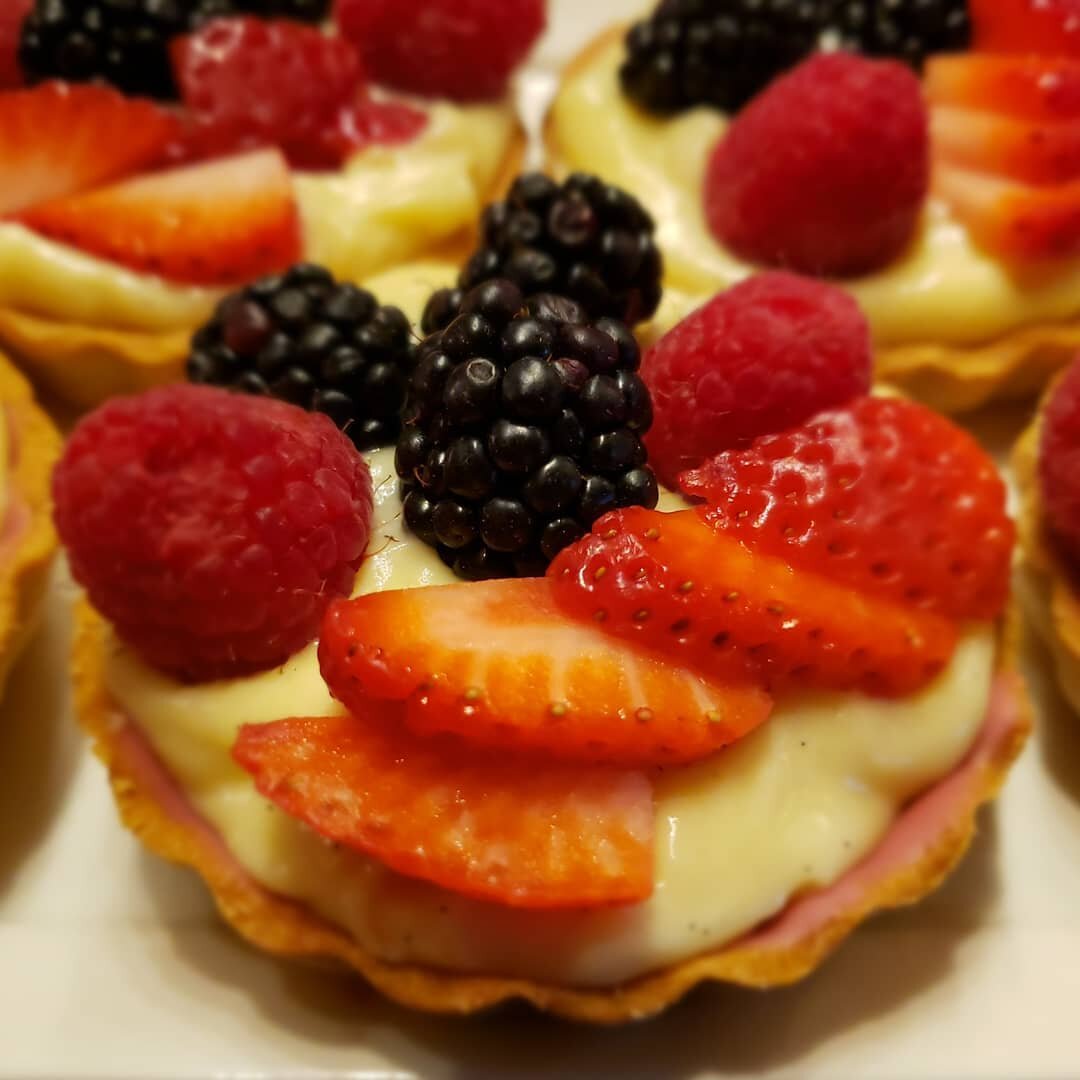 Two, ok 3-4, bite fruit tarts with vanilla pastry cream.