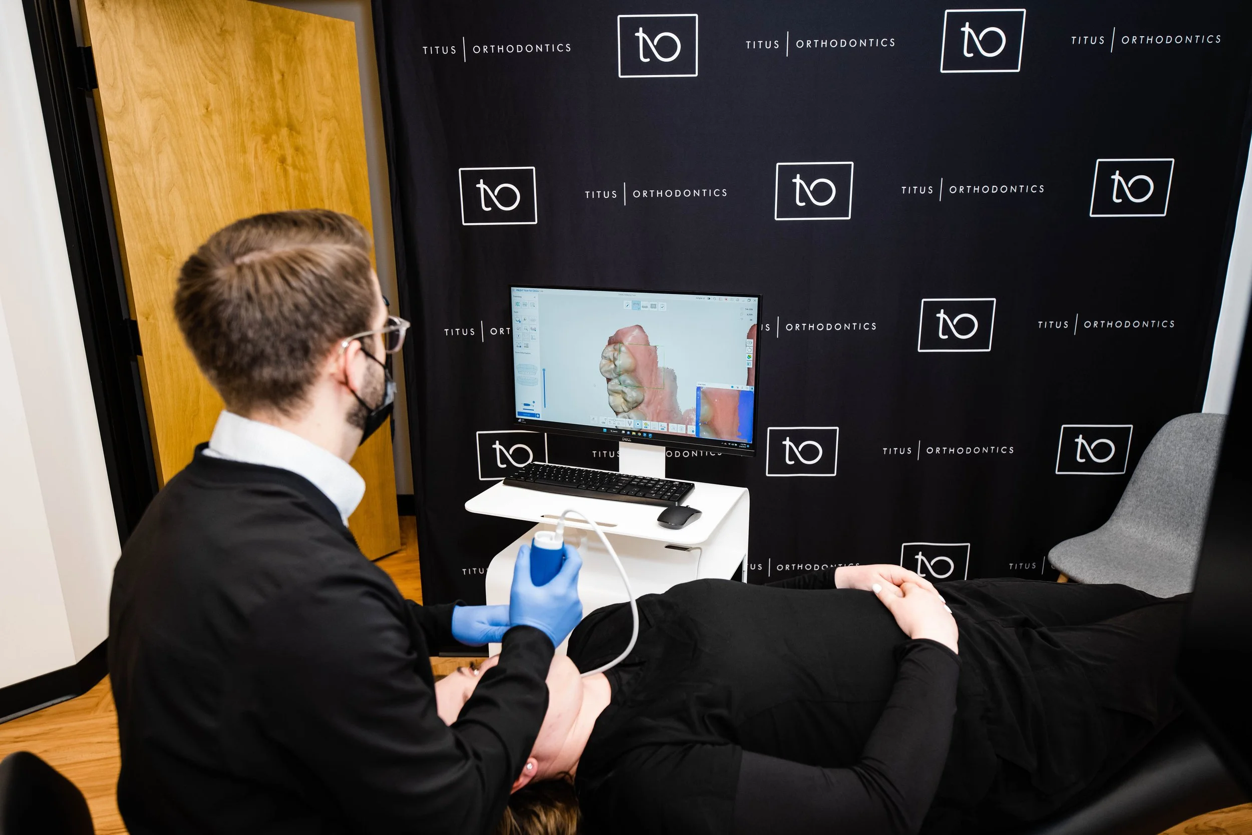 Dental staff demonstrating orthodontic technology during a patient consultation - How Does Invisalign Work in Westfield, IN?