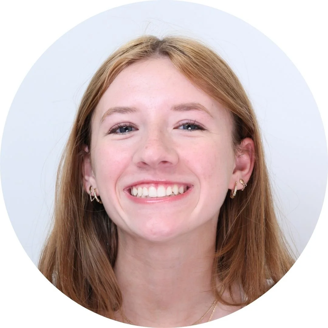 Portrait of a young woman smiling against a light background - Overbite vs. Underbite in Westfield, IN