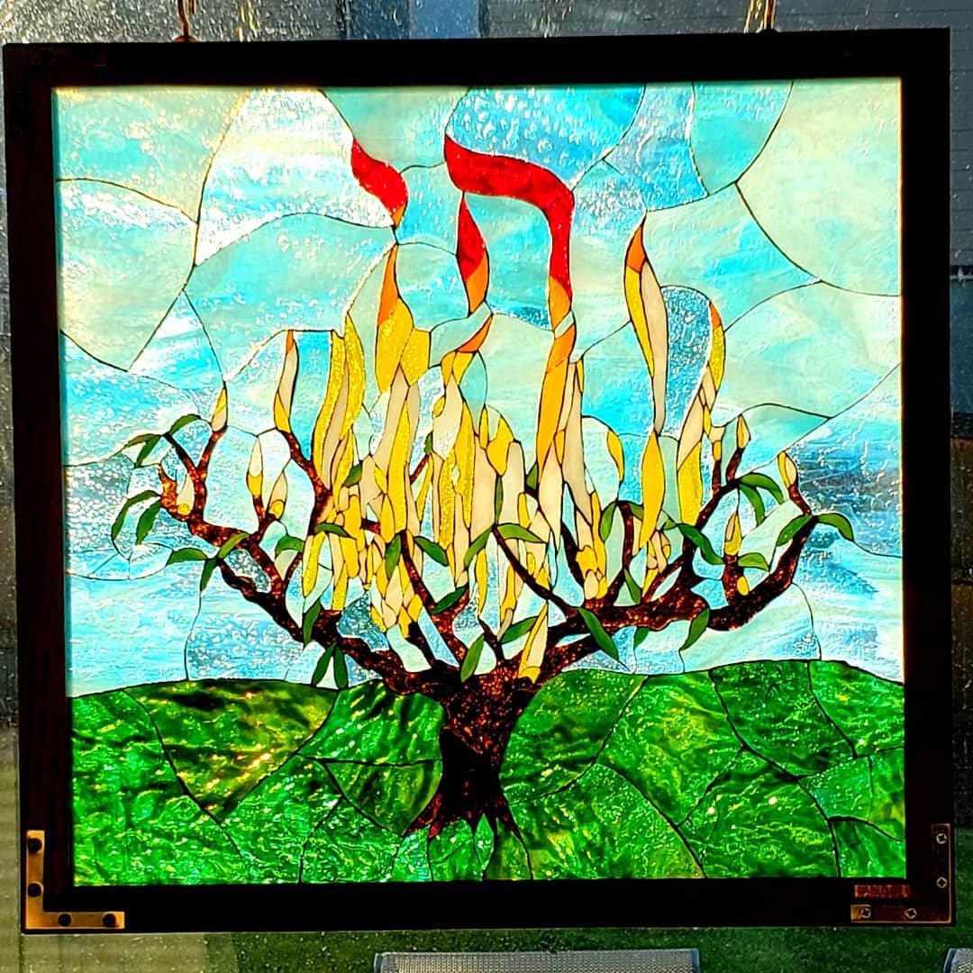 This particular glass mosaic will be a gift for the Tree of Life Synagogue in Pittsburgh, PA as a memorial to the congregants who lost their lives in the shooting in Oct. 2018.  The Hebrew letters spelling chai, life, rise from the flames of the burn