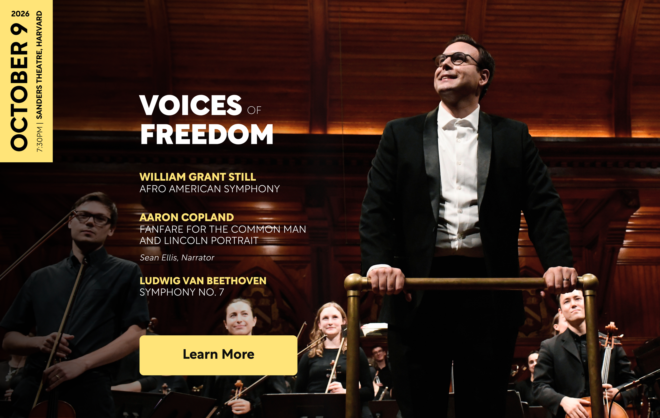 A conductor joyfully looking at the audience, with orchestra smiling at him.