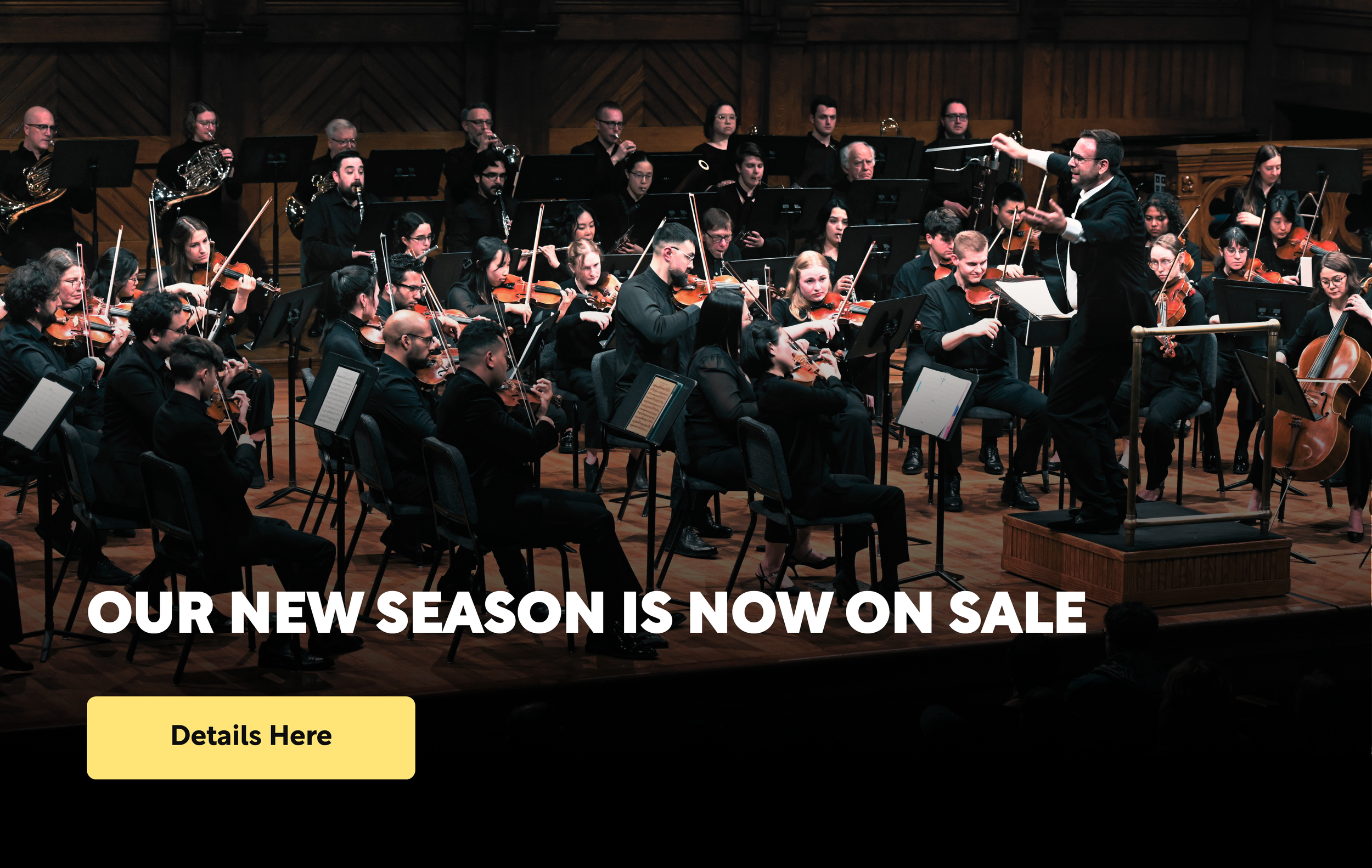 A large orchestra playing music, with a conductor waiving his baton joyfully.