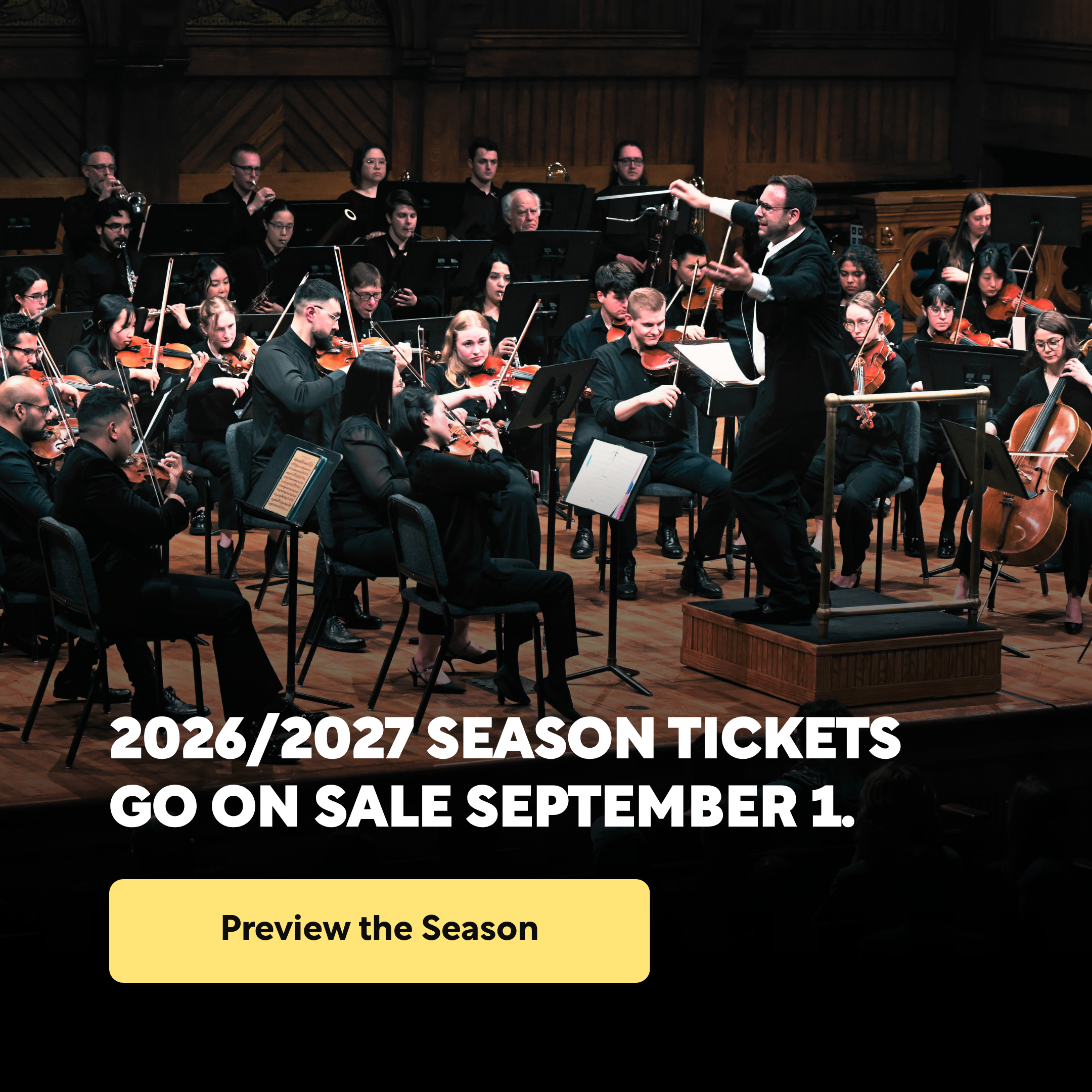 A large orchestra playing music, with a conductor waiving his baton joyfully.