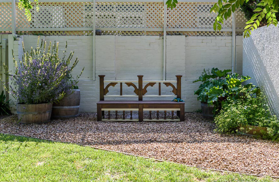 Country style garden and landscaping with custom built bench seat. Image: VSTYLE