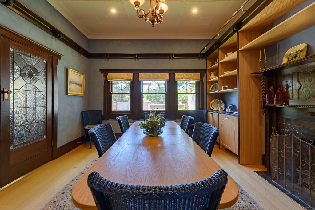 The dining room retained the original leadlight doors, windows, ceilings and fireplace. Image: VSTYLE