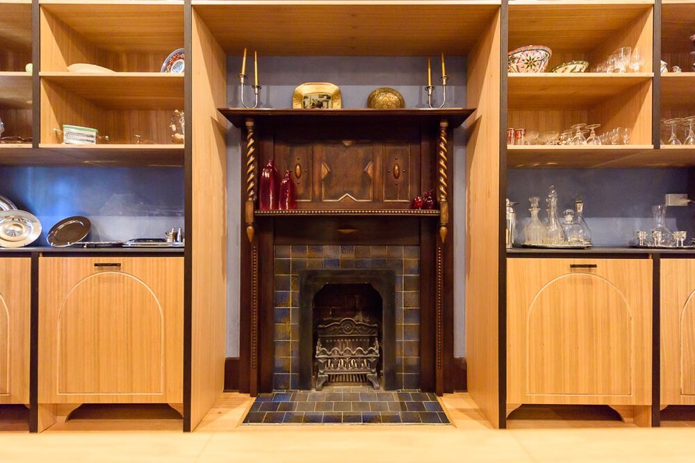 Original fireplace and tiling. Discoveries of the original tilework in the dining and kitchen areas dictated the colour scheme, blue and caramel, which is used throughout. Image: VSTYLE