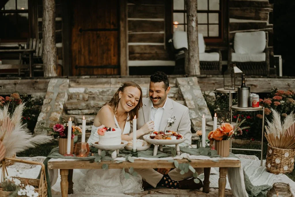 Couple laughing and enjoying themselves at a luxury picnic celebrating their elopement