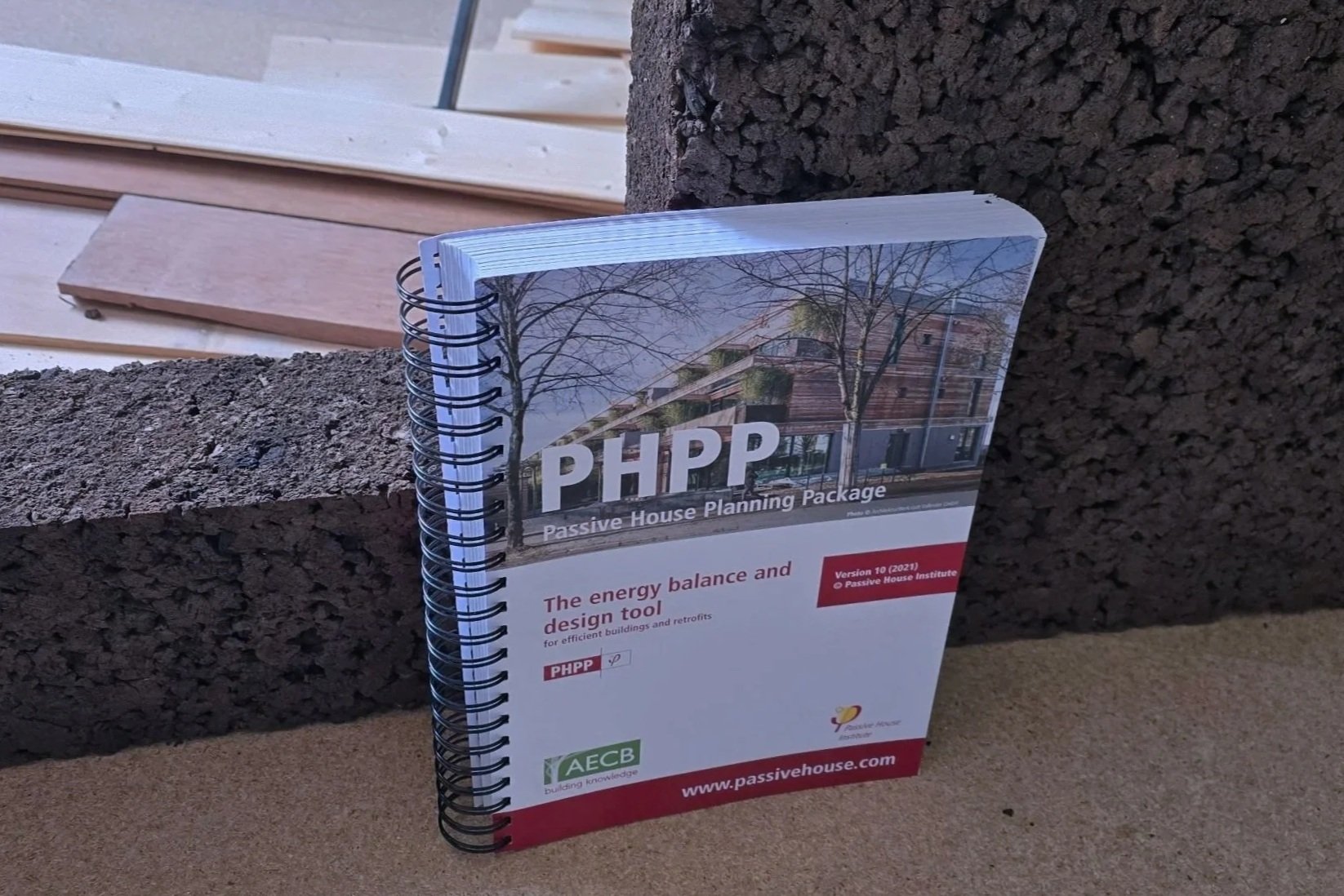 A cut slab of 100mm cork supporting the substantial PHPP manual