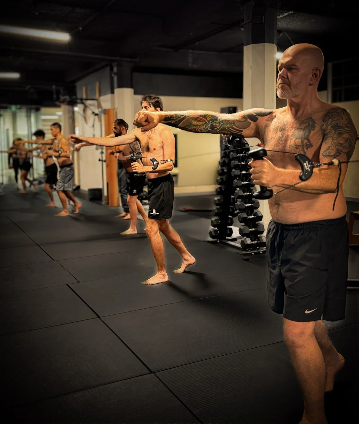 Participants practising standing cable exercises in a Functional Patterns Sydney group class.