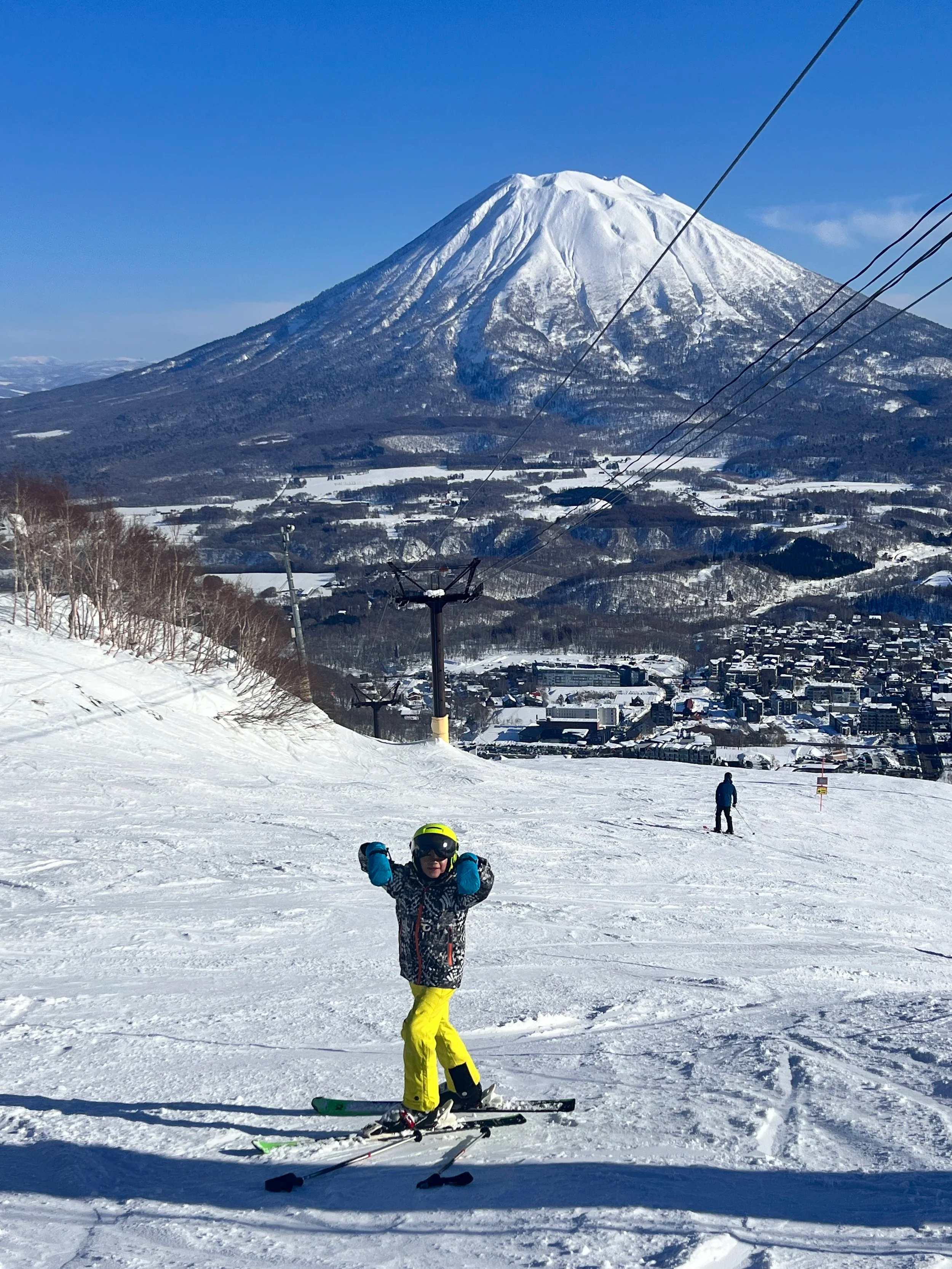 Boy skiing with mount annupuri in background
