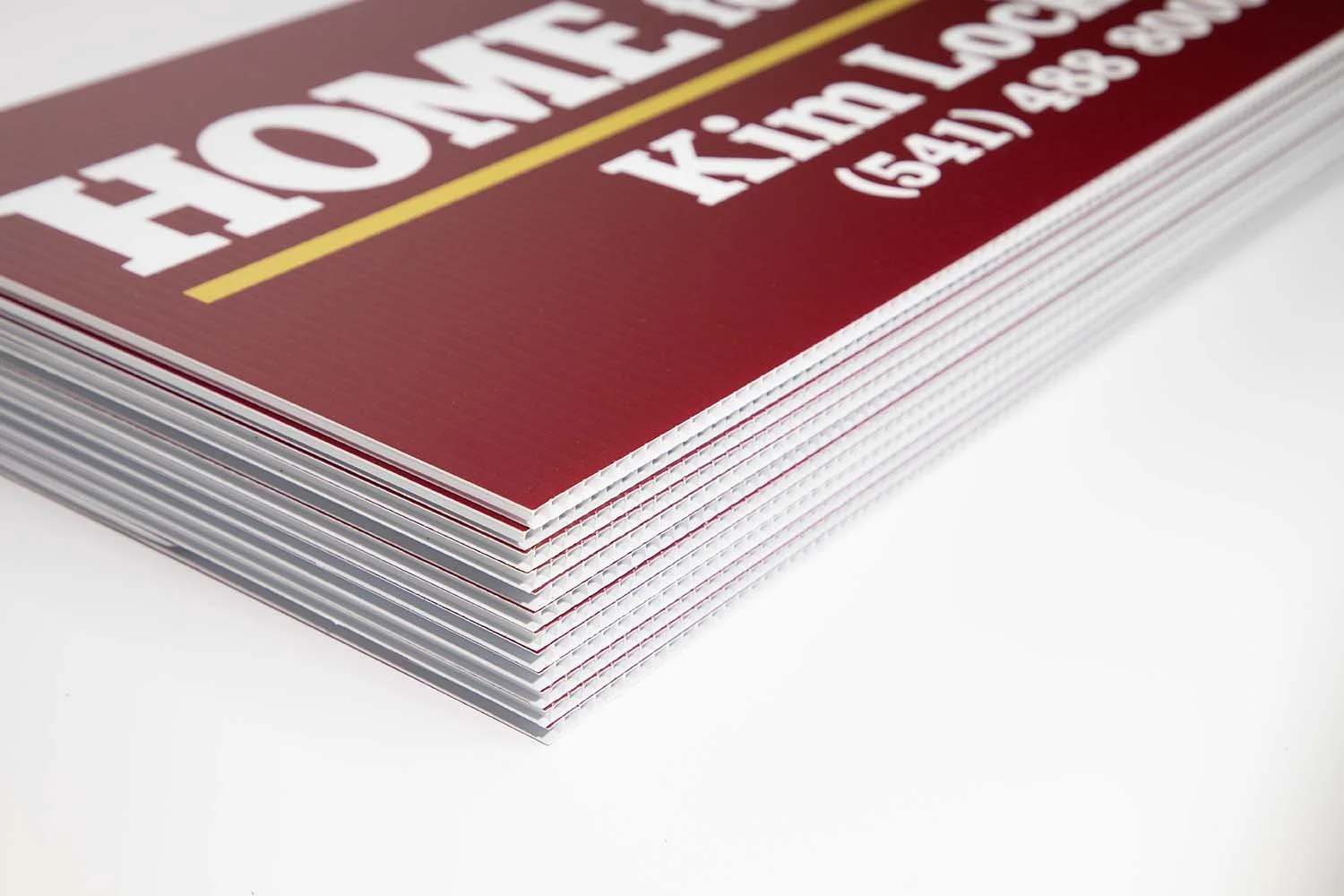 Stack of Arrow Shaped Real Estate Yard Sign Riders