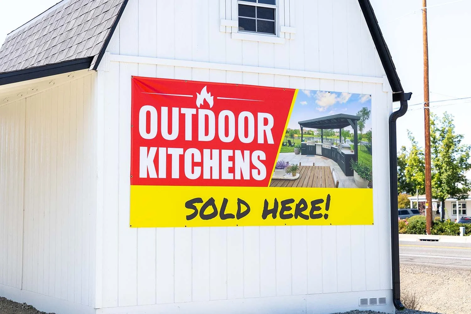 Outdoor Kitchens Banner Screwed onto a Shed
