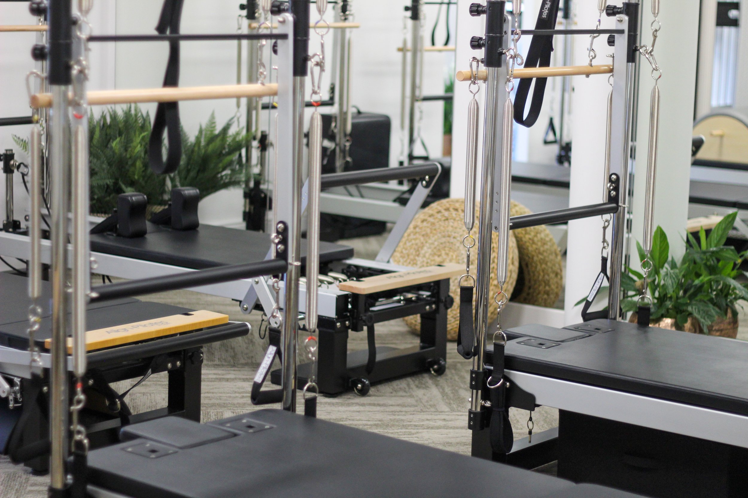 Rehab or physical therapy equipment including parallel bars, trapeze bars, and spring loaded rods in a rehabilitation or physiotherapy clinic.