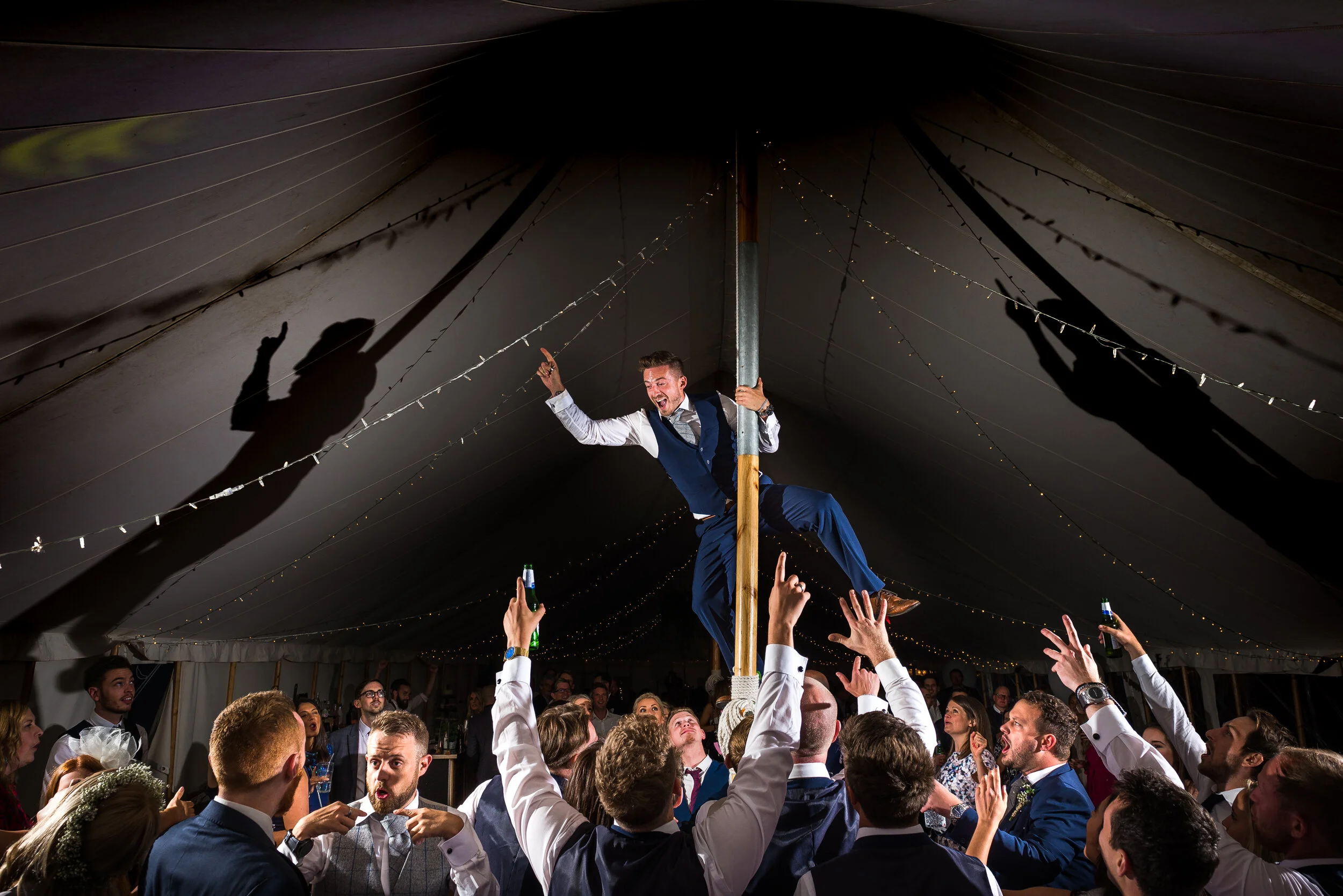 marquee wedding party groomsmen dancing on pole, Harrogate North Yorkshire 