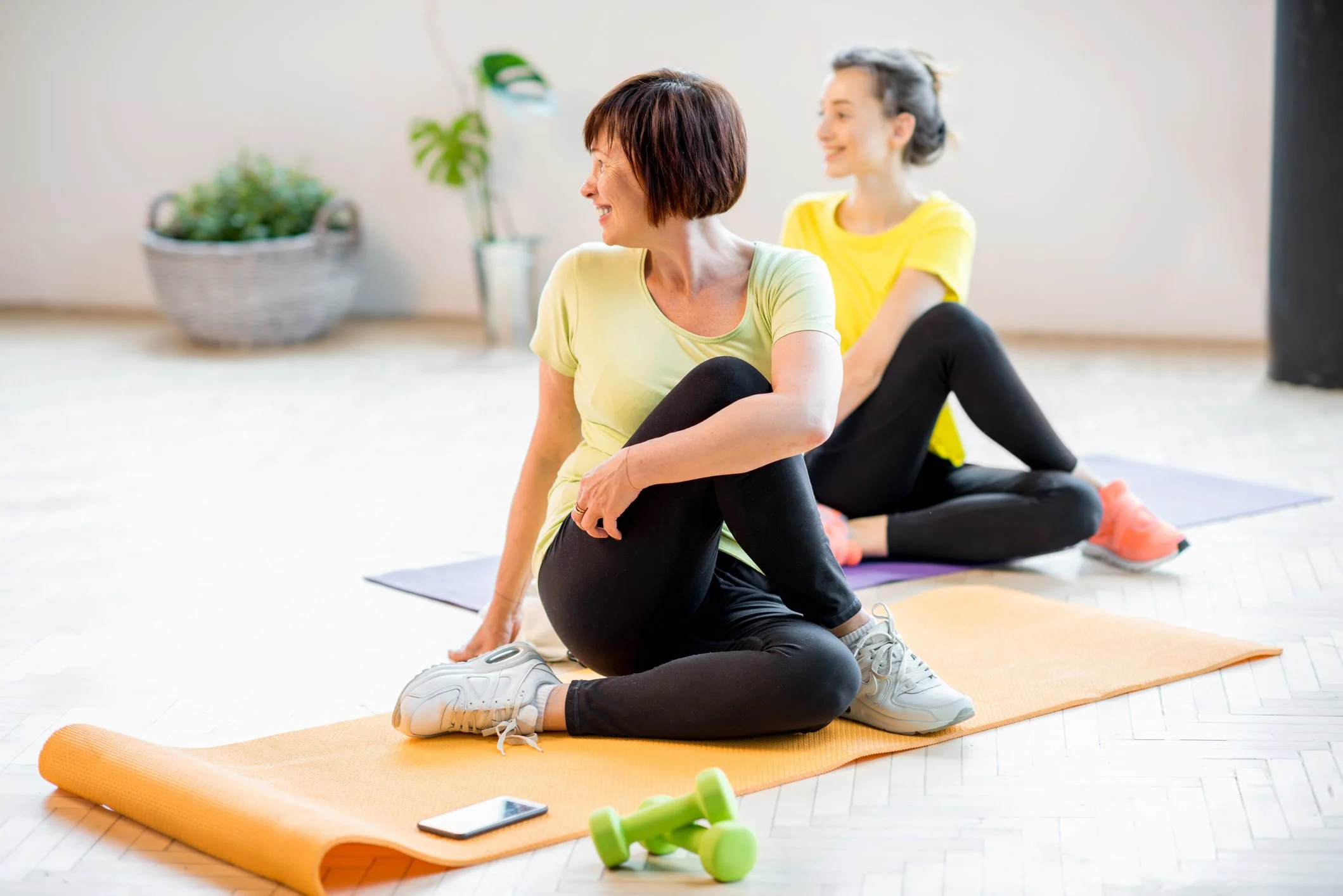 Young and older women doing yoga