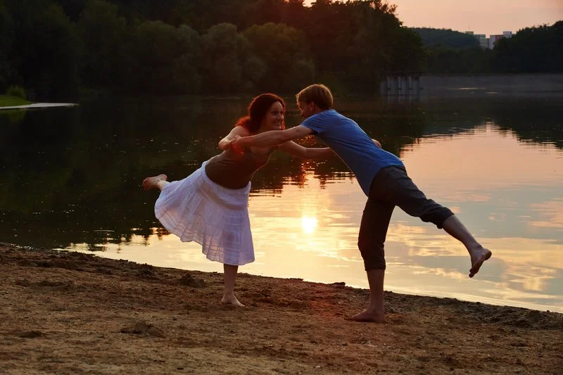 Warrior III partner yoga beach.jpeg