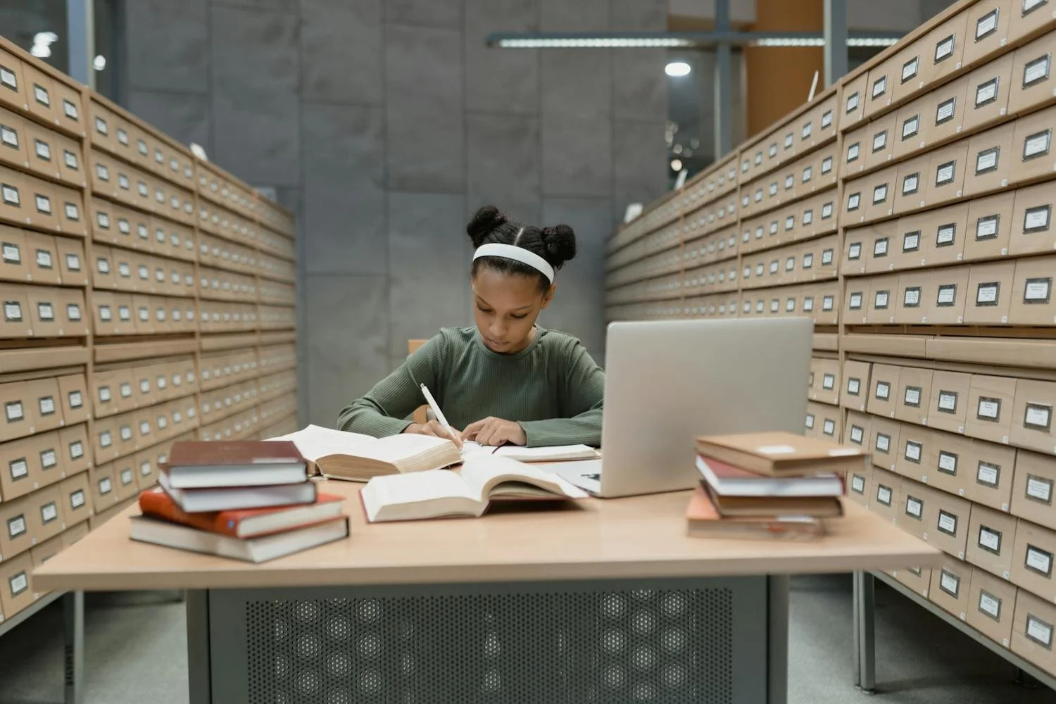 Student studying during summer with books or laptop