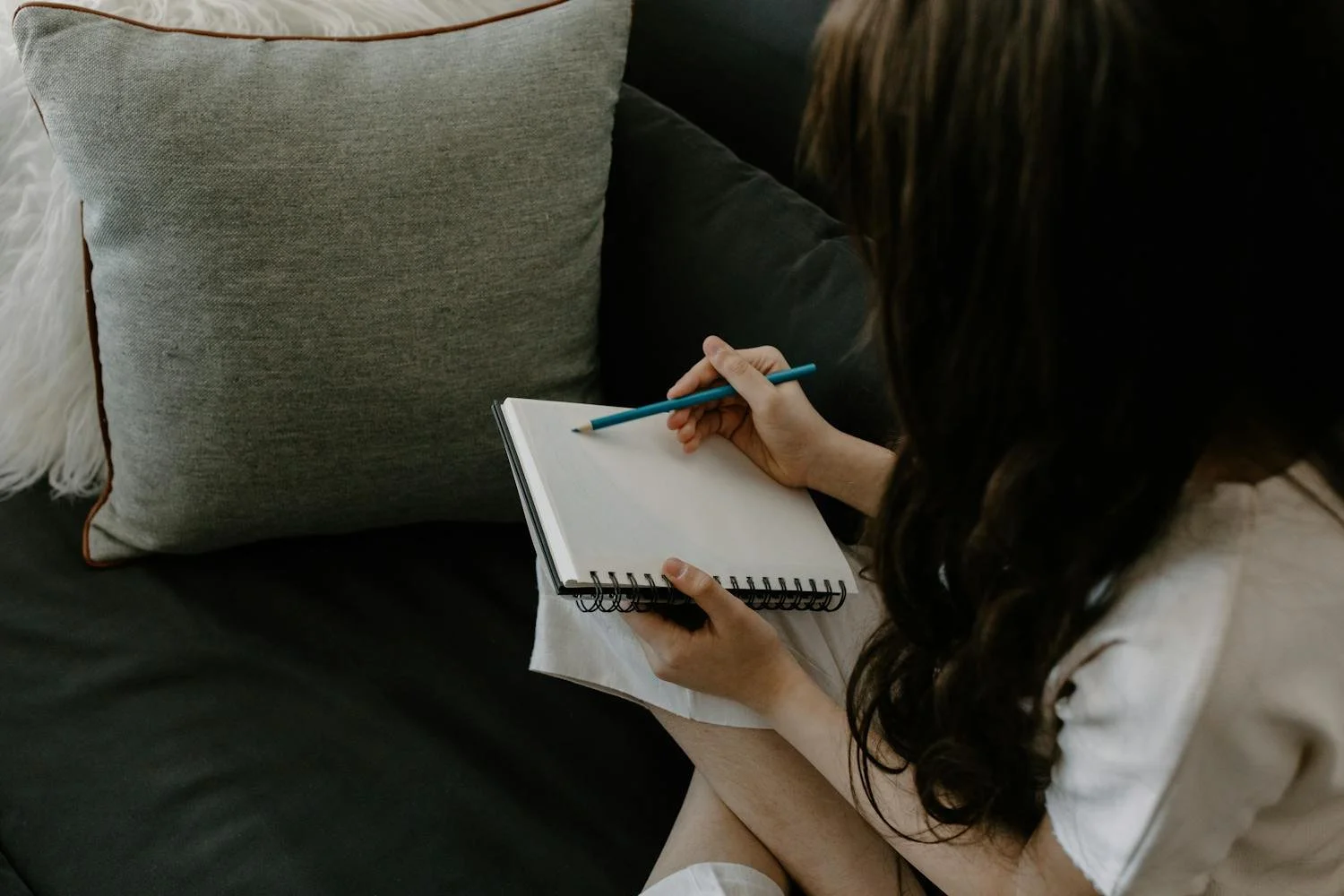 A student writing on a blank page