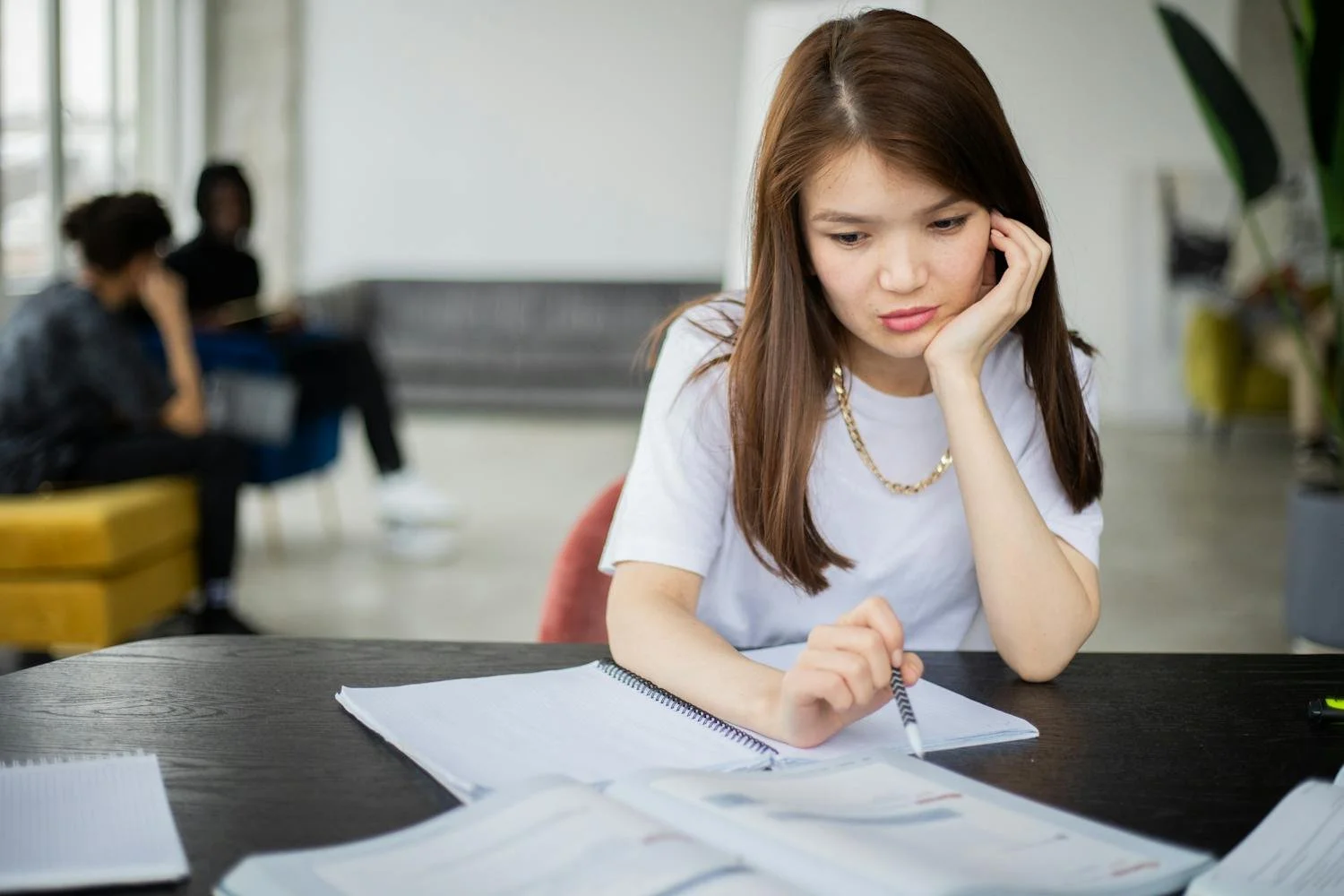 Student reviewing notes and textbooks before school starts