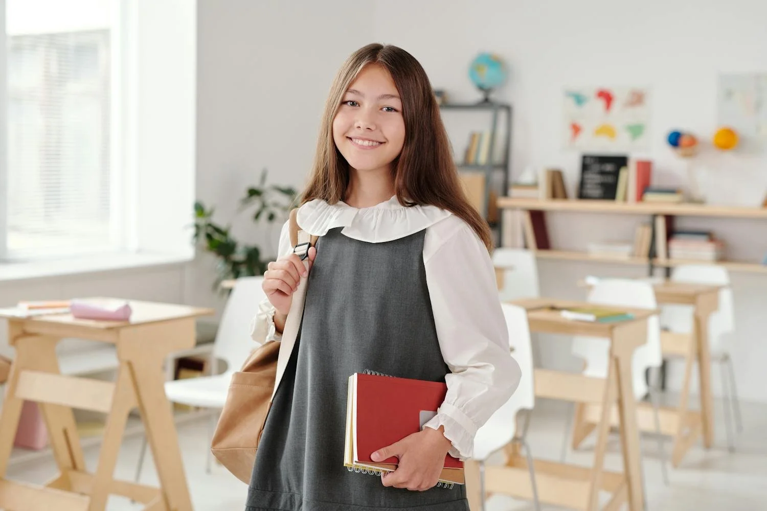 Student entering high school classroom with Math textbooks