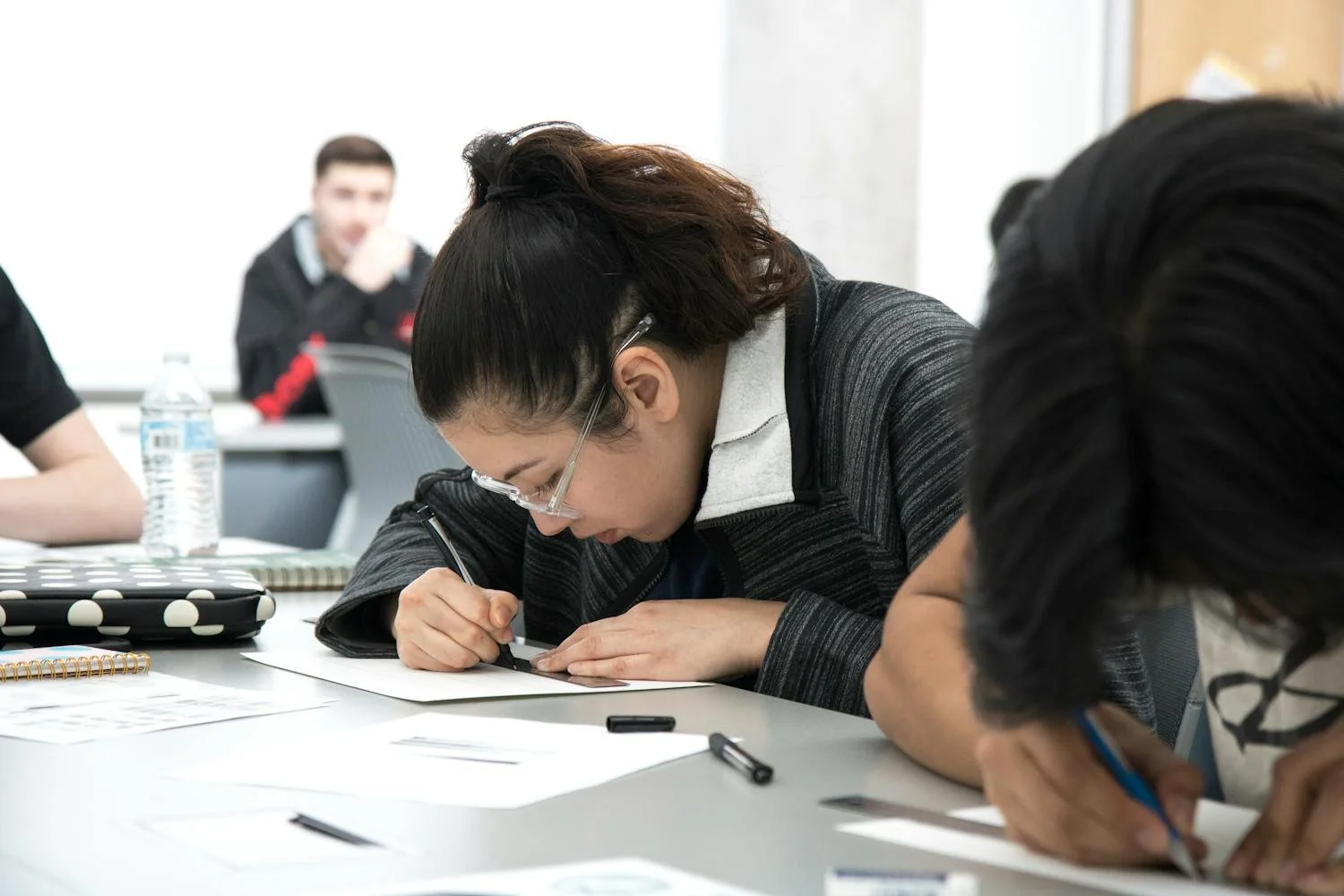 Student drawing physics diagram to understand motion and forces