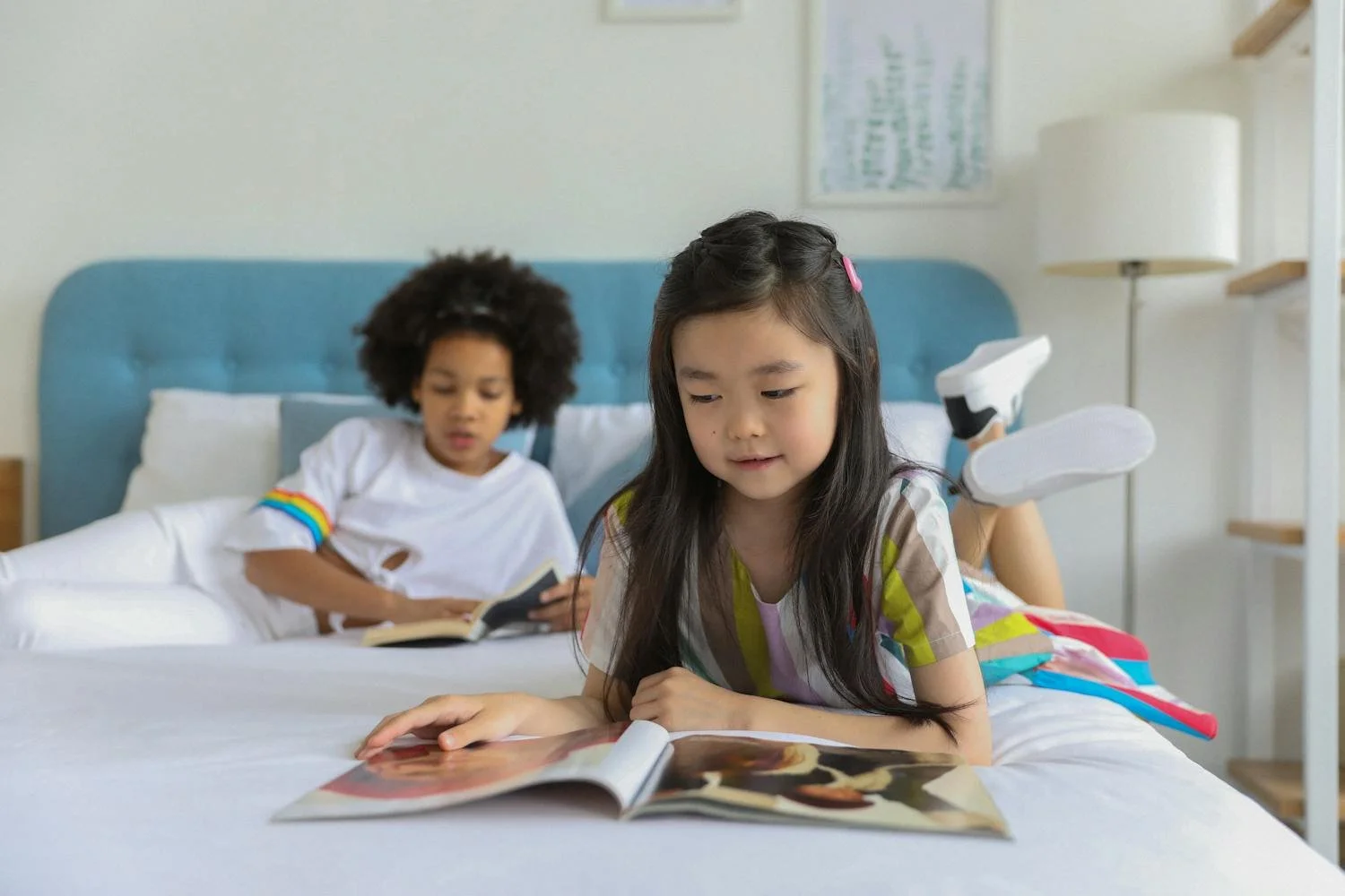 Young girl reading about a successful woman in STEM and seeing herself in a future career