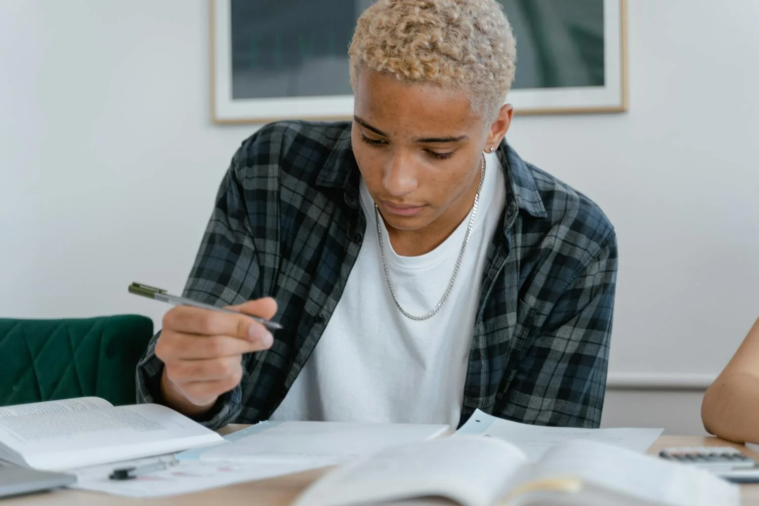 Student solving linear equations in notebook