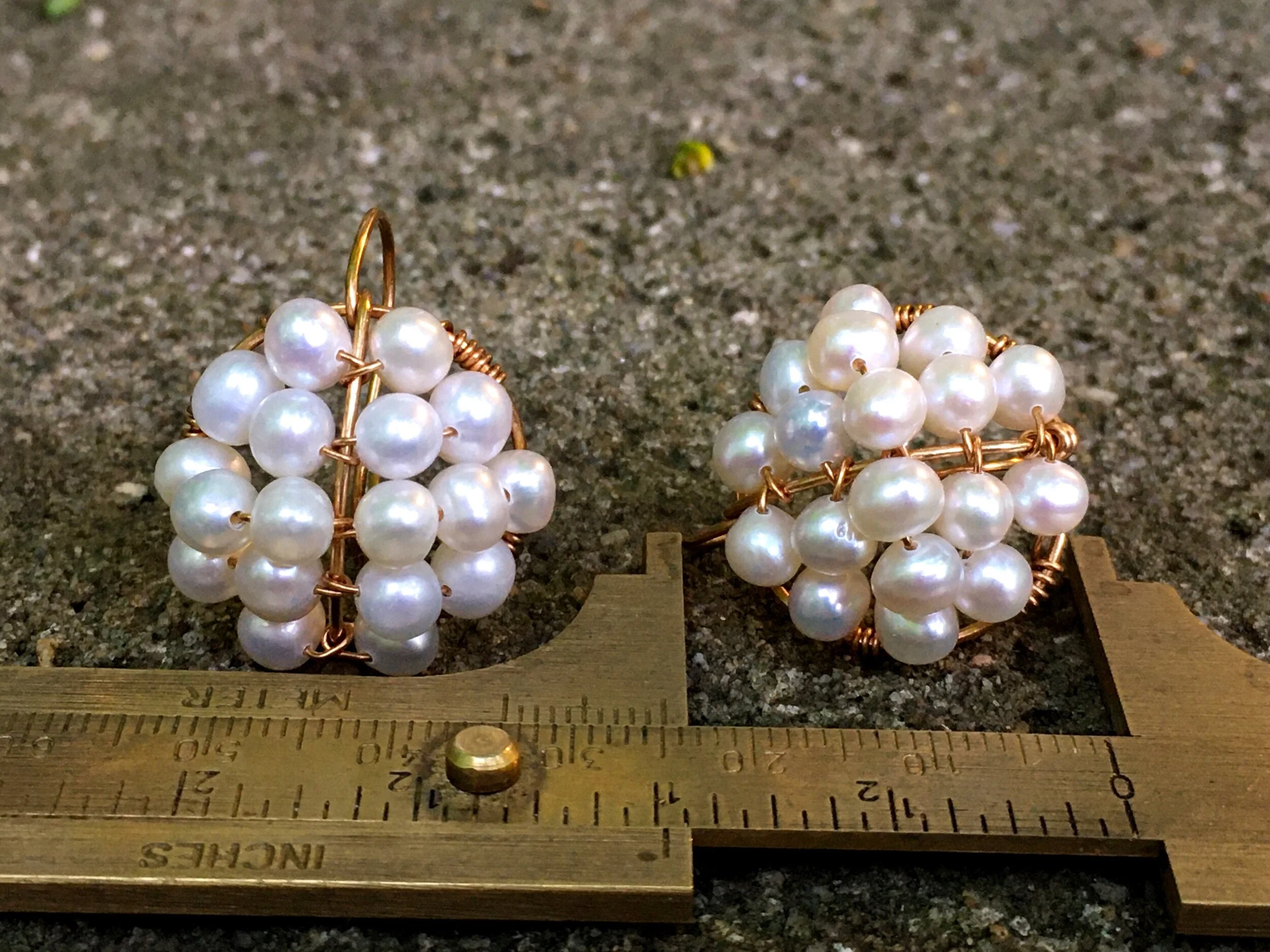 Bronze and freshwater pearl Roman-style cluster earrings with a brass gauge for scale. The earrings are about one inch long.