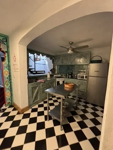 The kitchen is fully equipped with handcrafted tiles