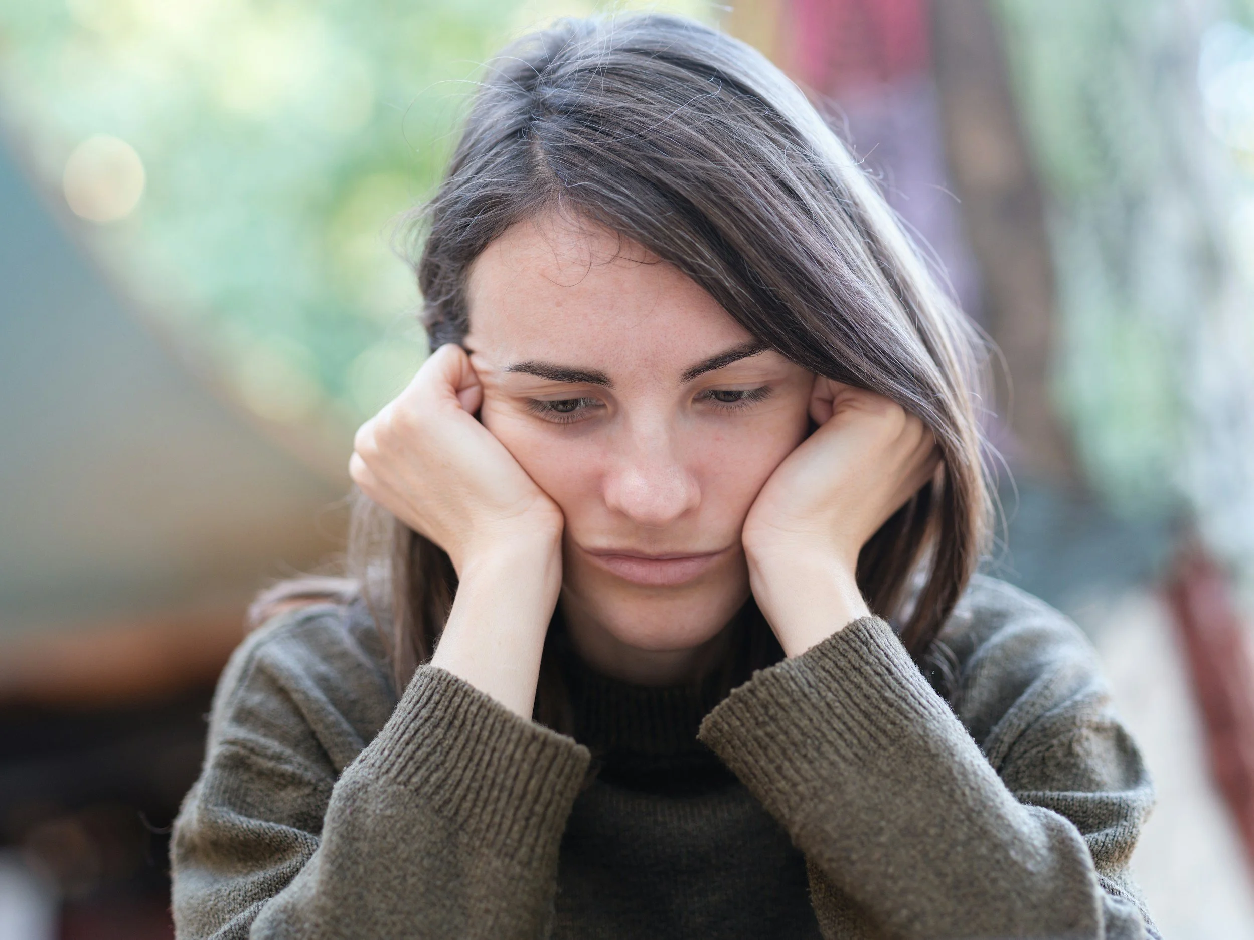 woman weighing problems, deciding if she is dealing with trauma or general anxiety