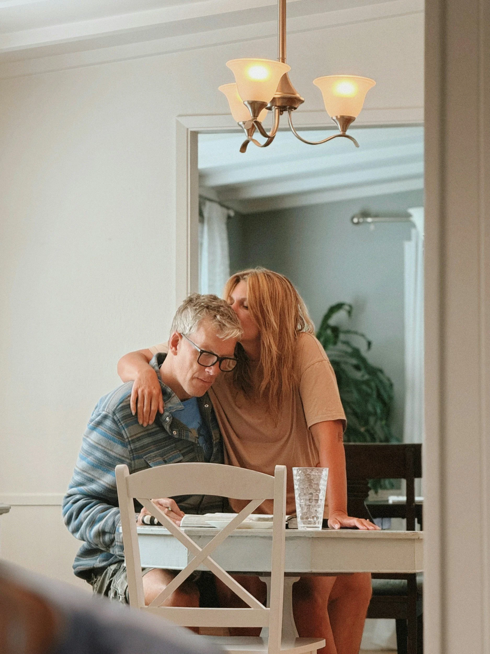 woman comforting man after couples session where she learned why he reacts the way he does