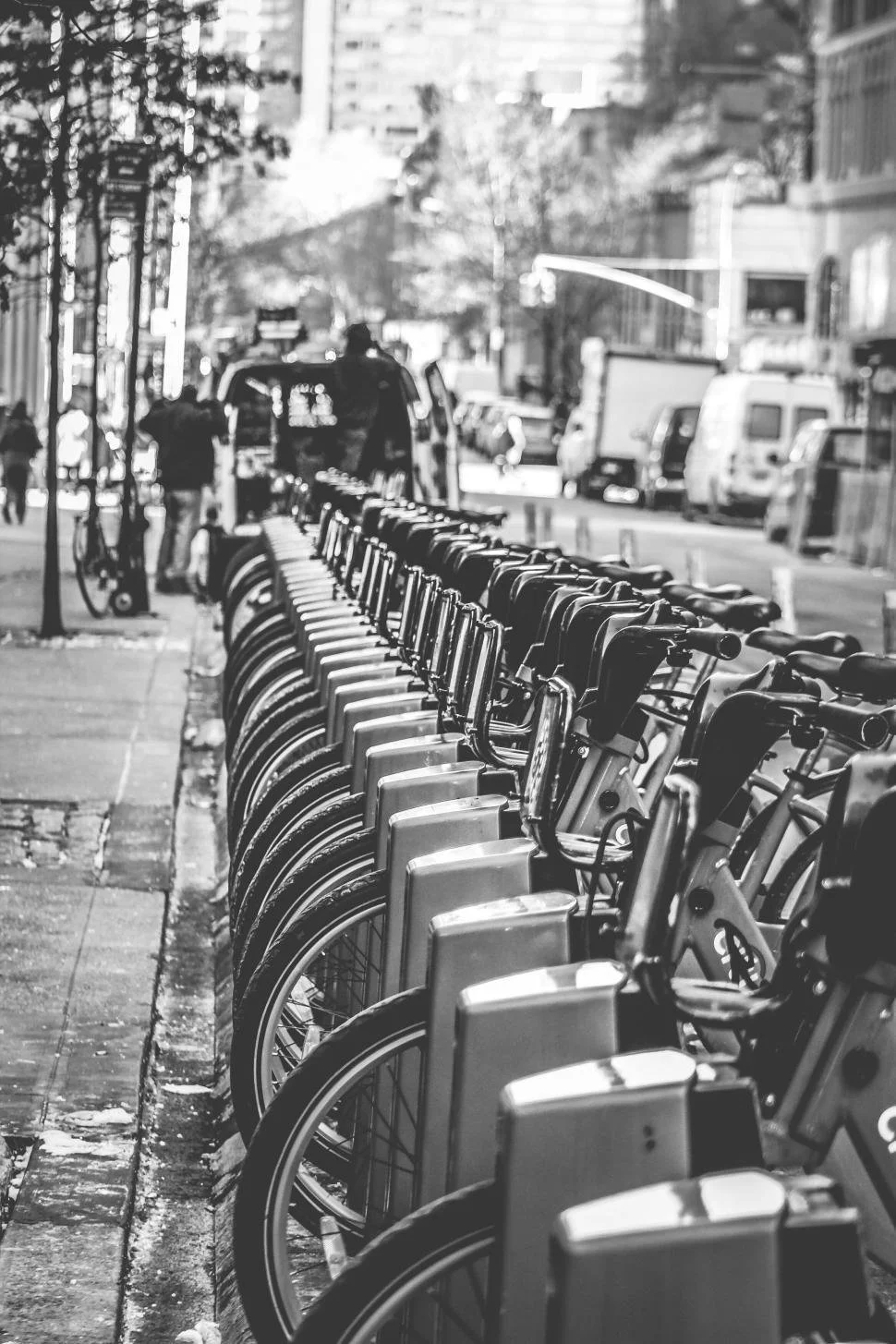 row-of-bicycles-at-a-bike-sharing-station-on-a-busy-city-sidewalk..jpg