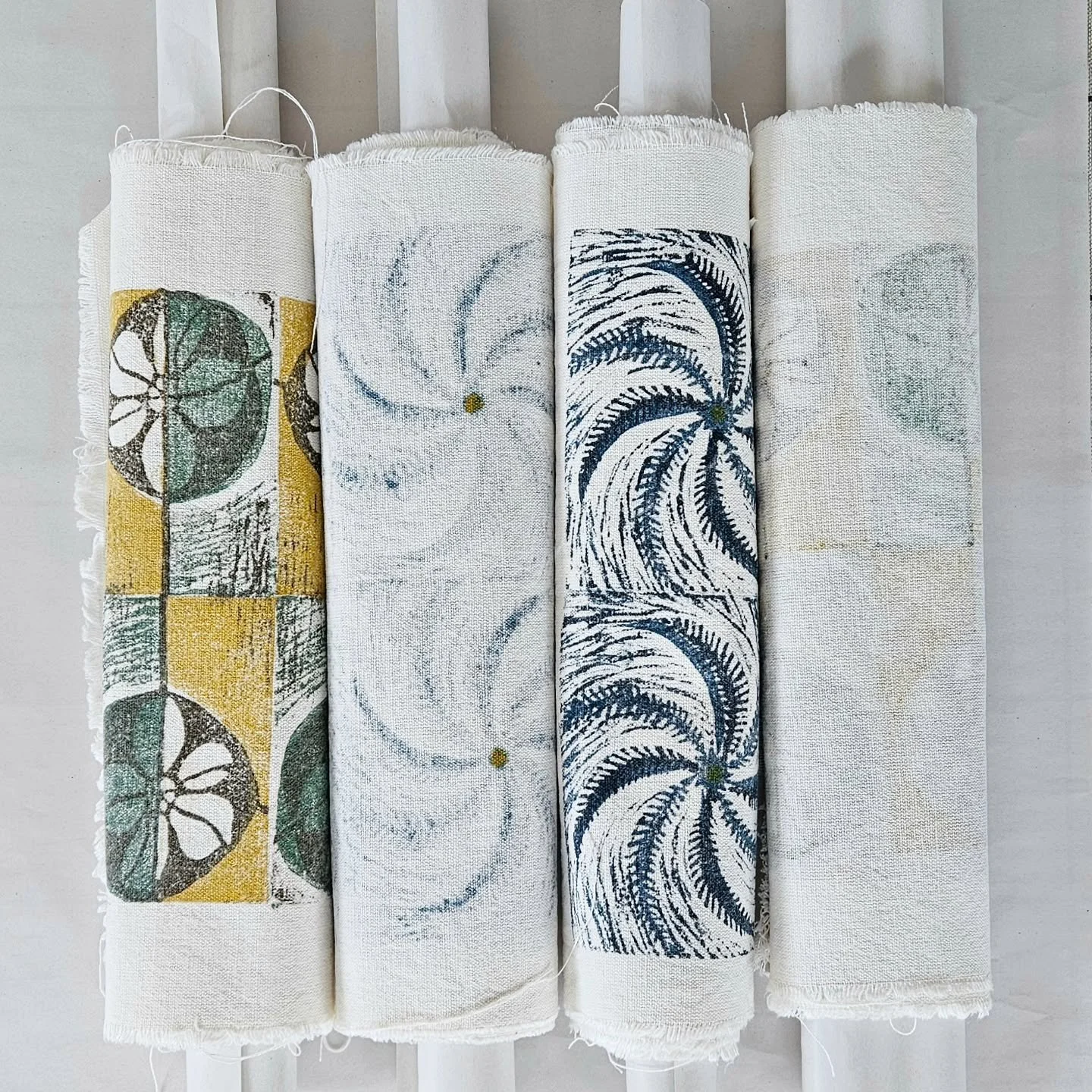 Four table runners (NEW!) rolled and ready to go off to my magician, Jill, to be made presentable.
#tablelinen #primrose #handprintedtextiles #linoprintedfabric 
@heritagecrafts @craftscouncil @find_a_maker